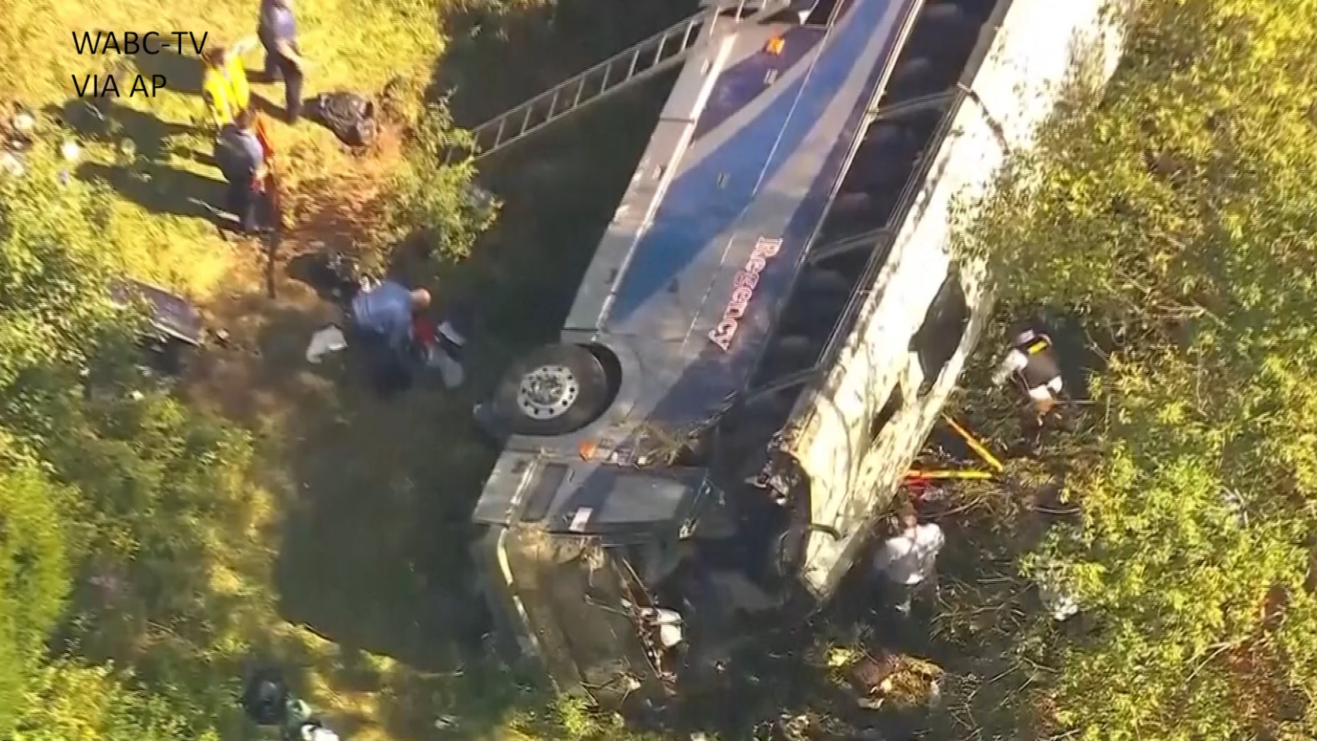 A charter bus carrying high school students to a band camp veered off a New York highway and tumbled down an embankment Thursday, killing two adults.