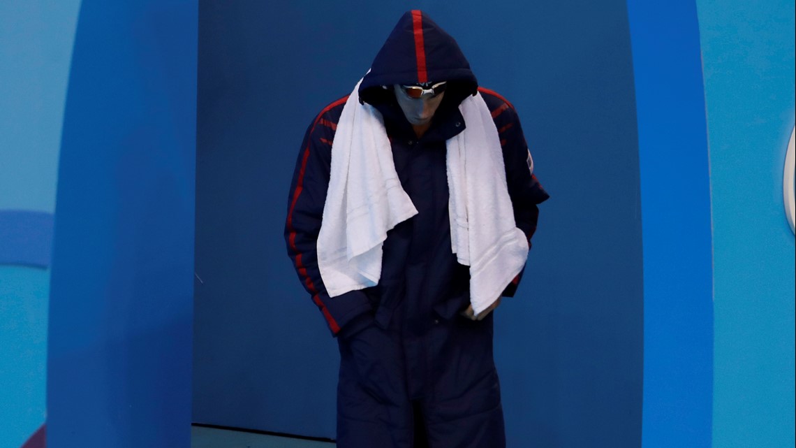 Why do Olympic swimmers slap themselves and wear coats?