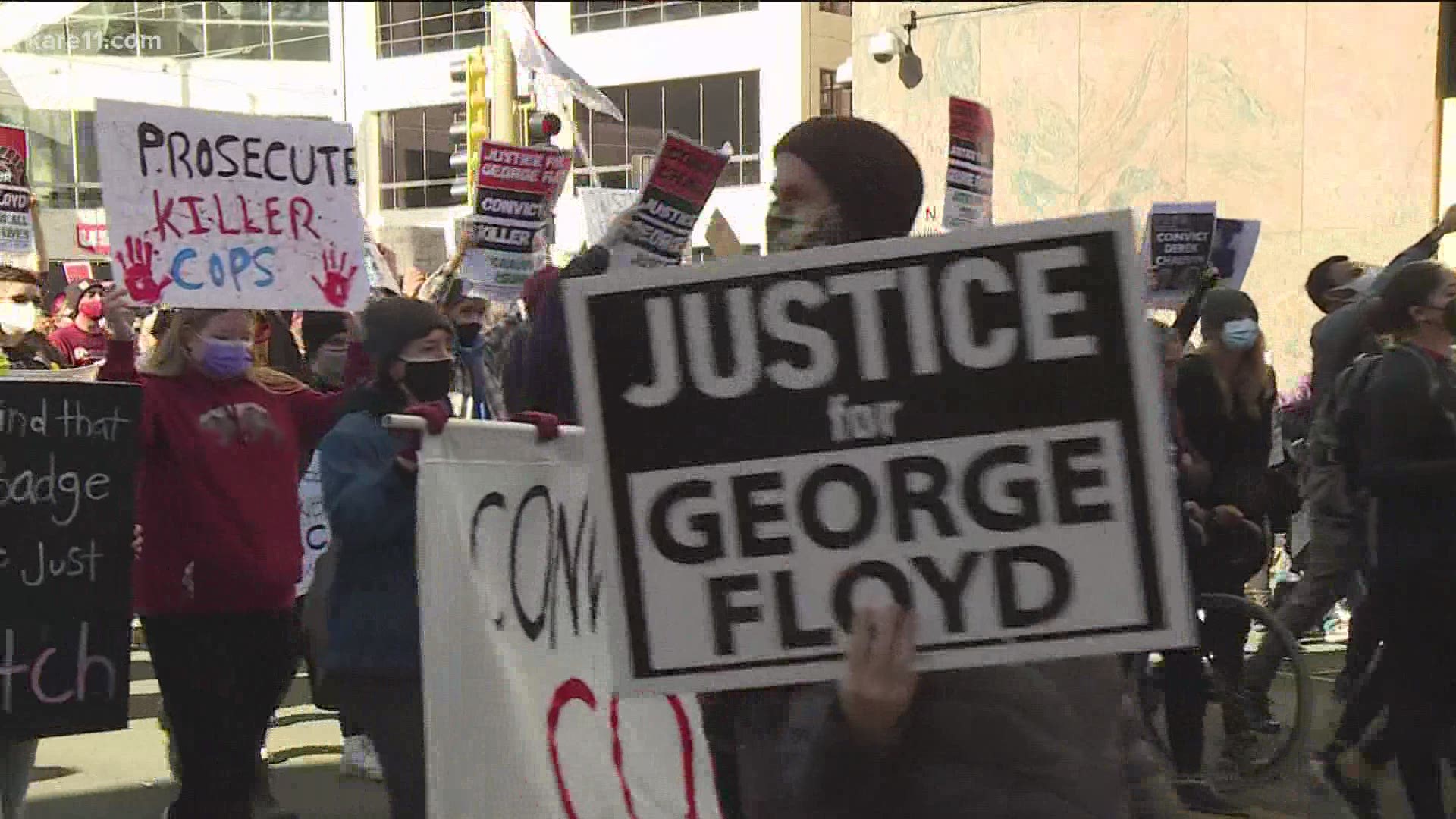 Demonstrators carried a banner reading "Justice 4 George & all stolen lives; the world is watching".