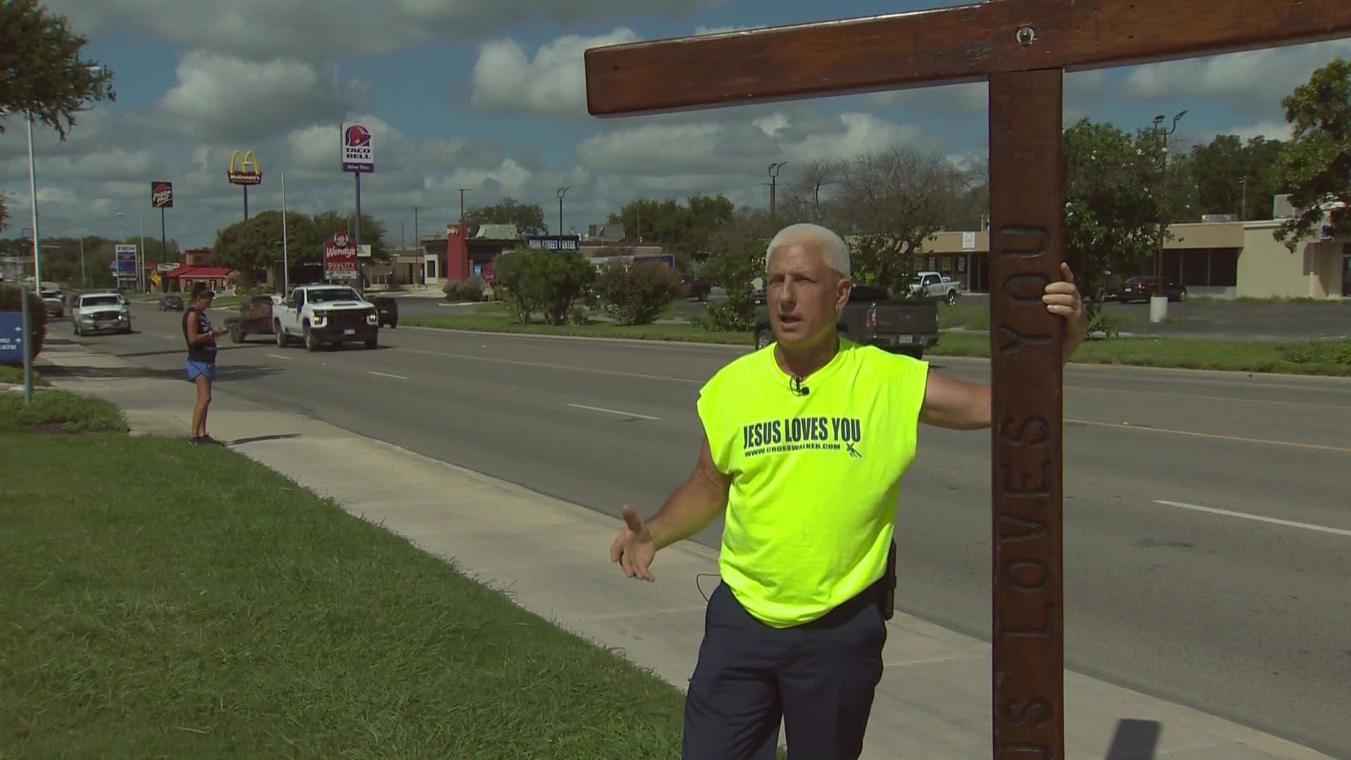 Bob Hanus is walking with a cross in support of the students returning to school today after the tragedy at Robb Elementary three months ago.