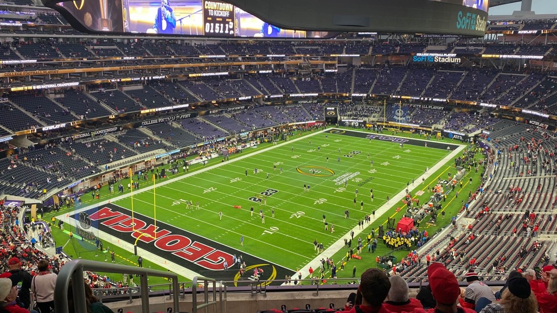 Fans at SoFi Stadium look on during a weather delay shortly before