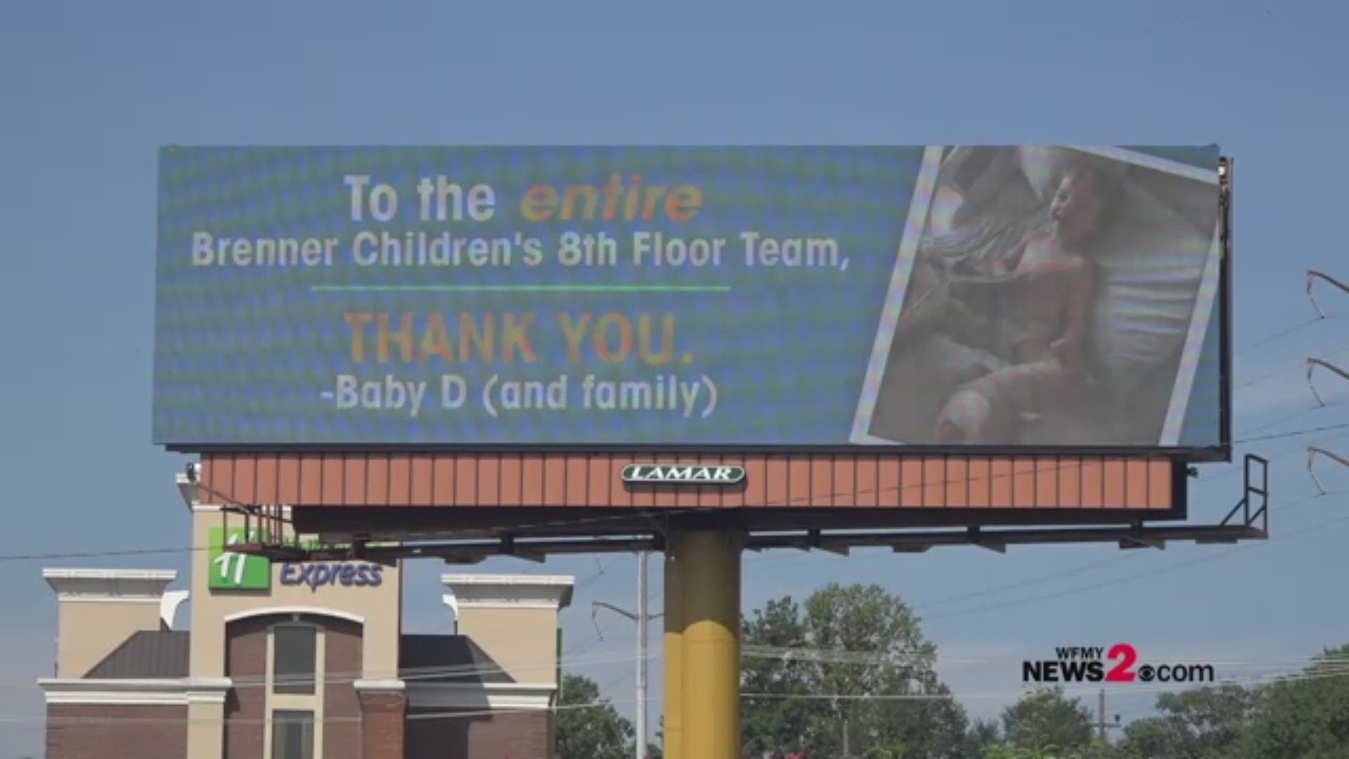 After a trip to the Brenner Children's Hospital, a dad thought the best way to thank the staff for caring for his baby was to set up a billboard. The message reads "To the entire Brenner Children's 8th Floor Team, Thank You. Baby D (and family)."