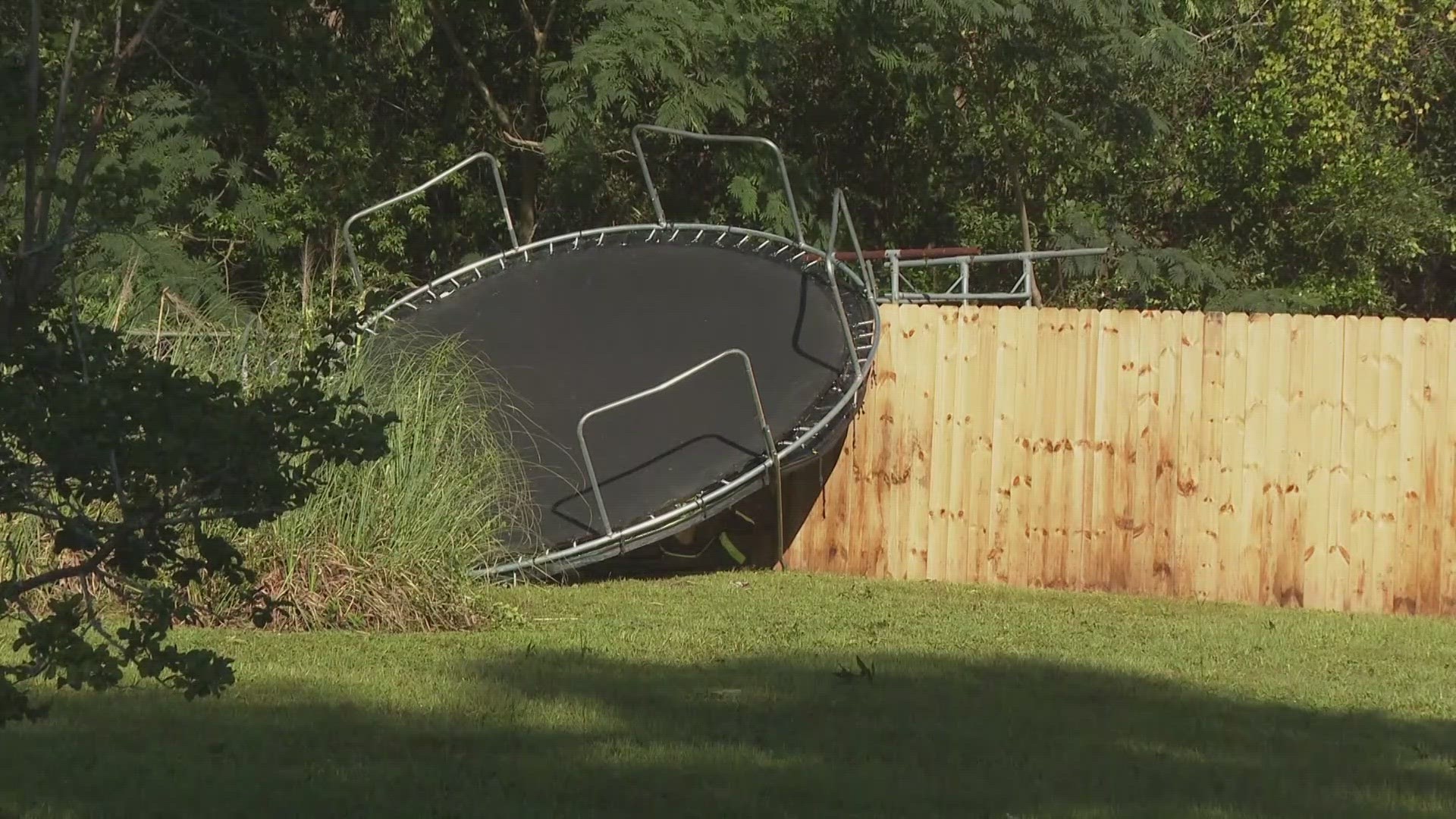 Winds blew a trampoline across a yard and toppled trees onto a home a roadways.