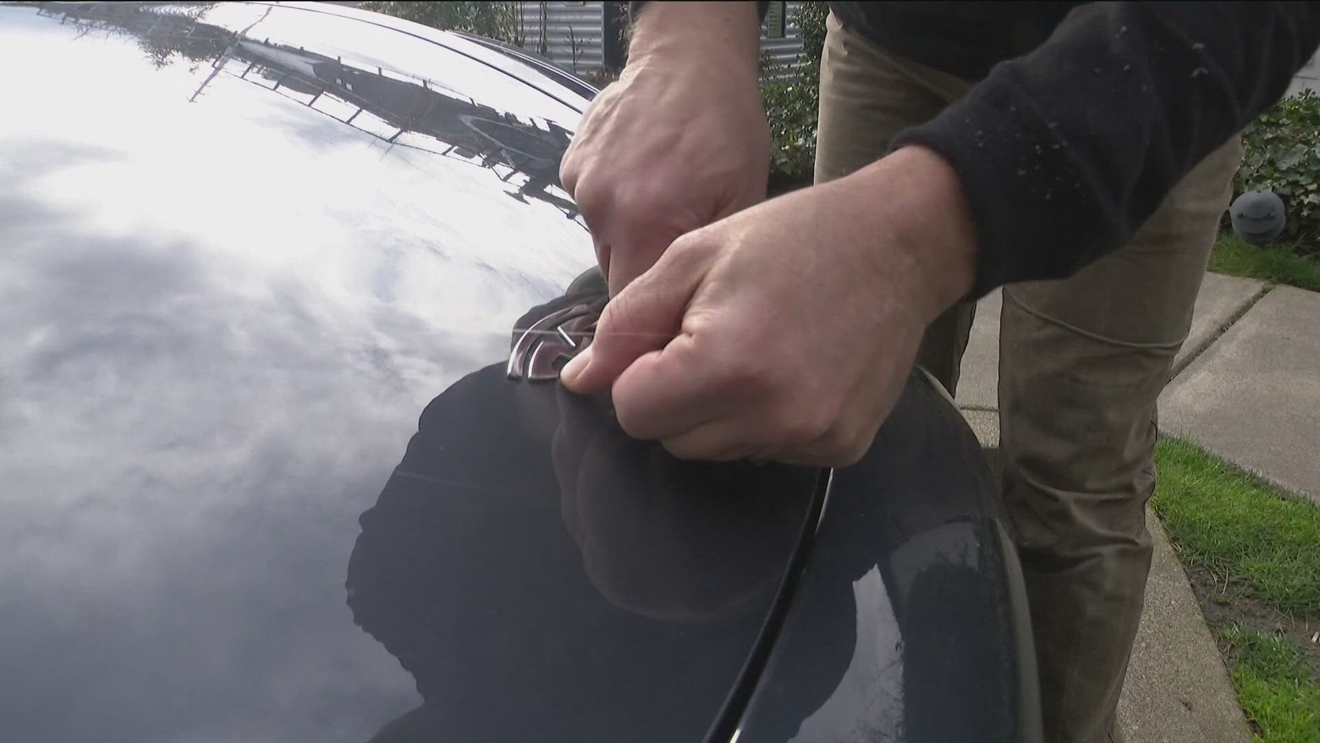 Using a heat gun, screw gun and fishing line, a Seattle man removed logos from his vehicles and several others.