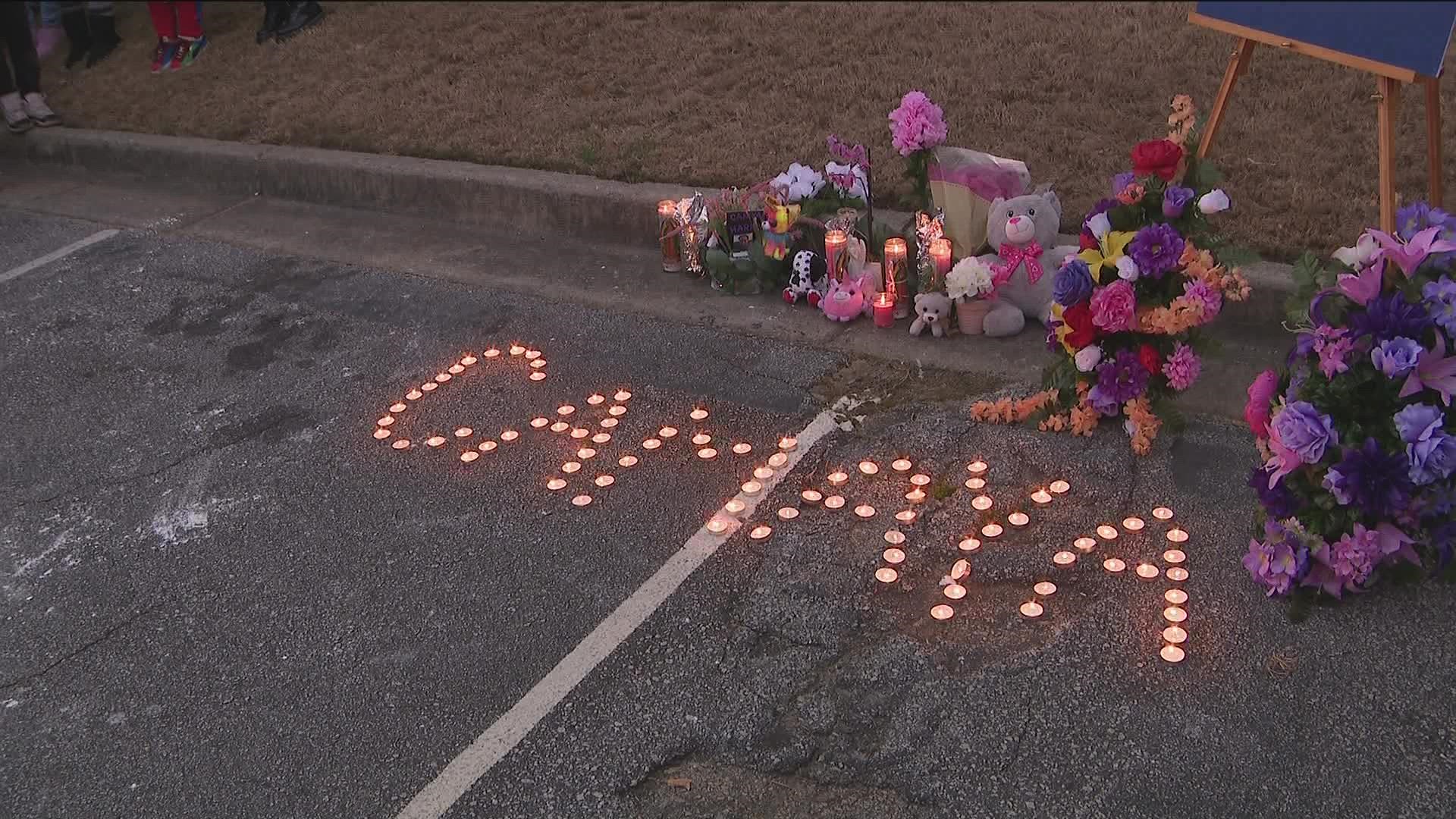 Candles illuminated Camaya's name at her vigil.