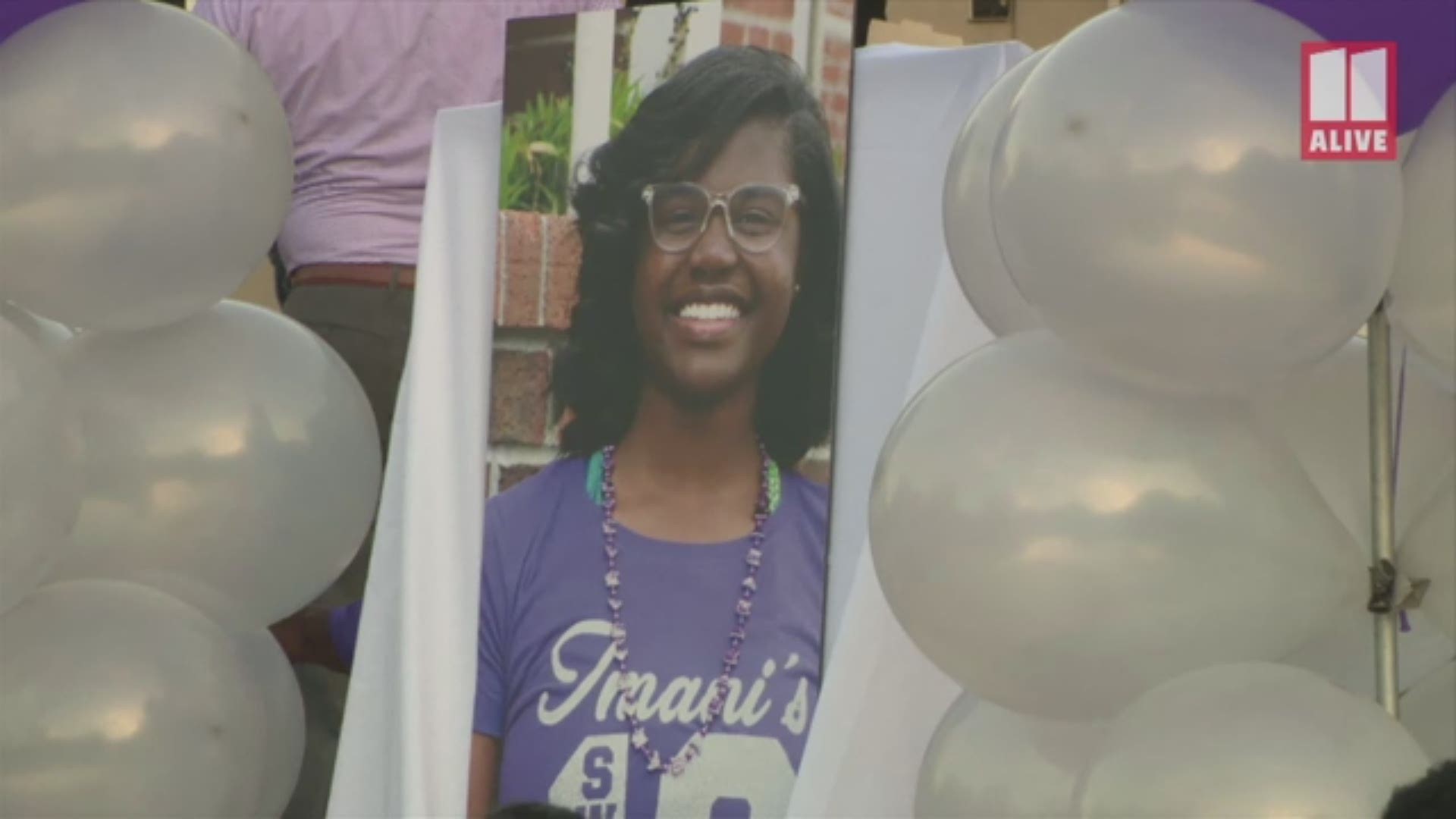 Imani Bell's family said she died after doing basketball drills in the heat. Her family and friends gathered for a vigil Wednesday.