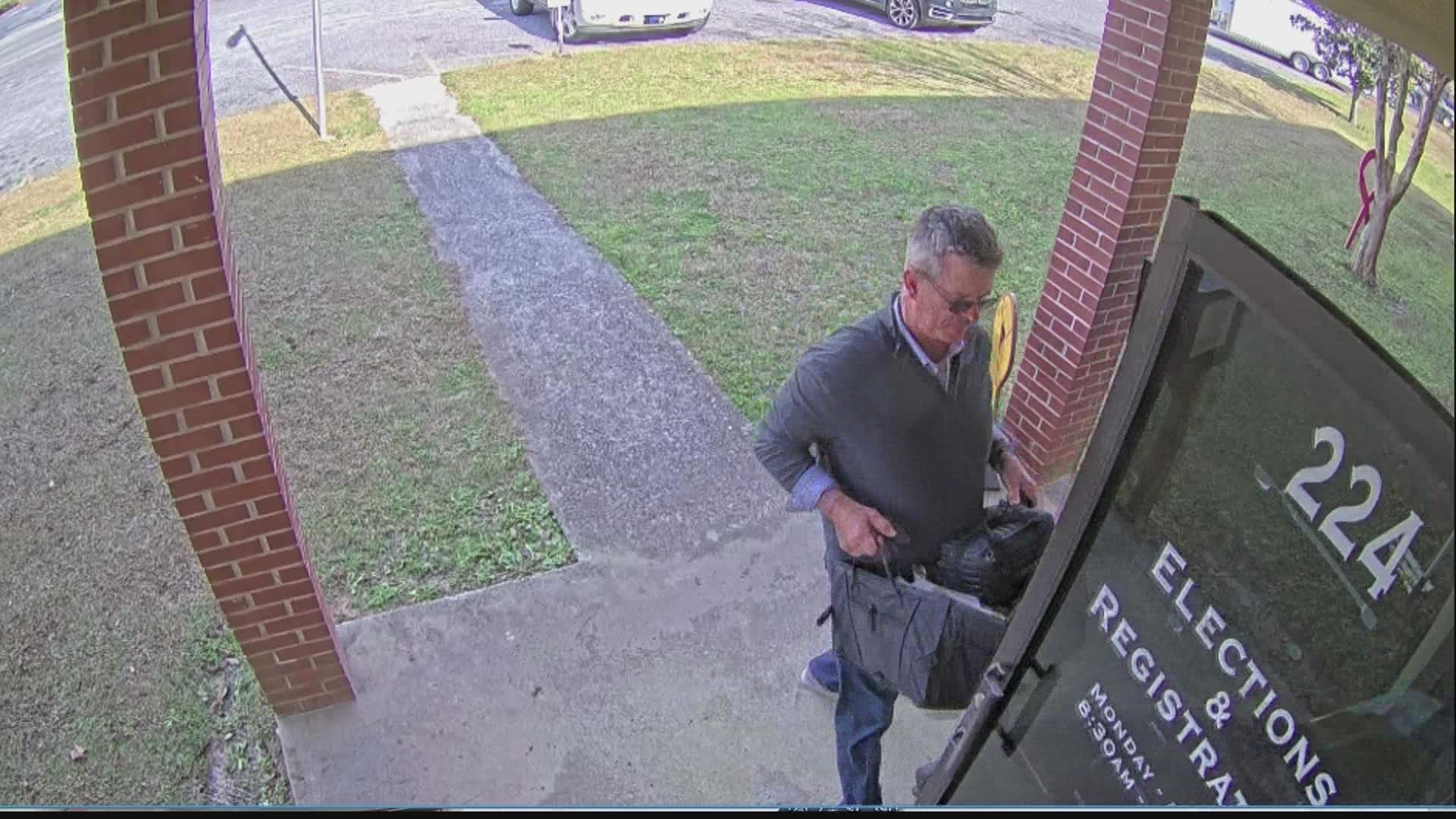 A security camera outside the elections office in rural Coffee County captured their arrival.
