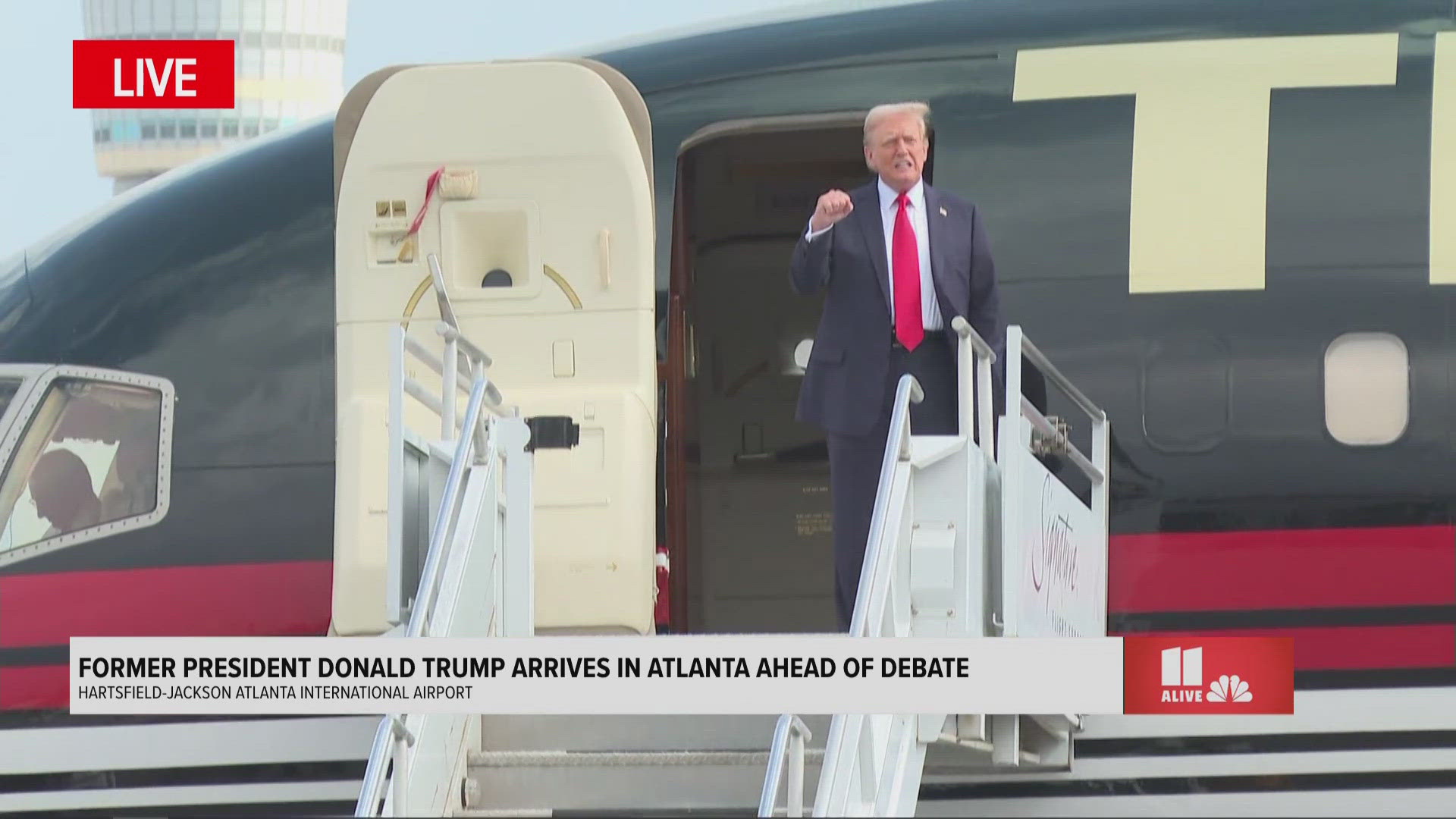 Trump waved to the crowd after getting off "Trump Force One" as he prepares for his debate against Joe Biden in Atlanta.