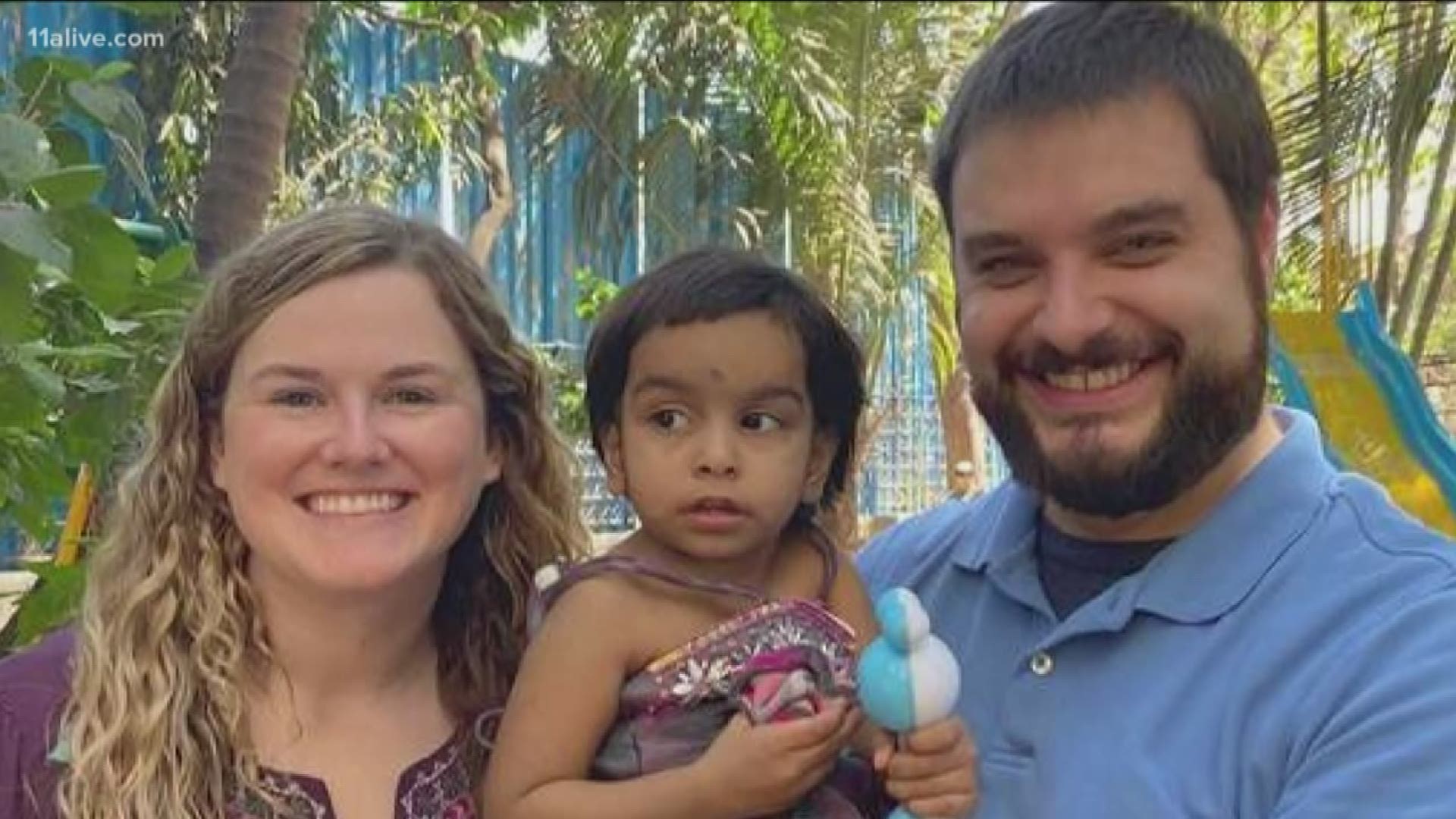 They went to India to bring home their new daughter. Now, they're trapped in the world's largest lockdown.