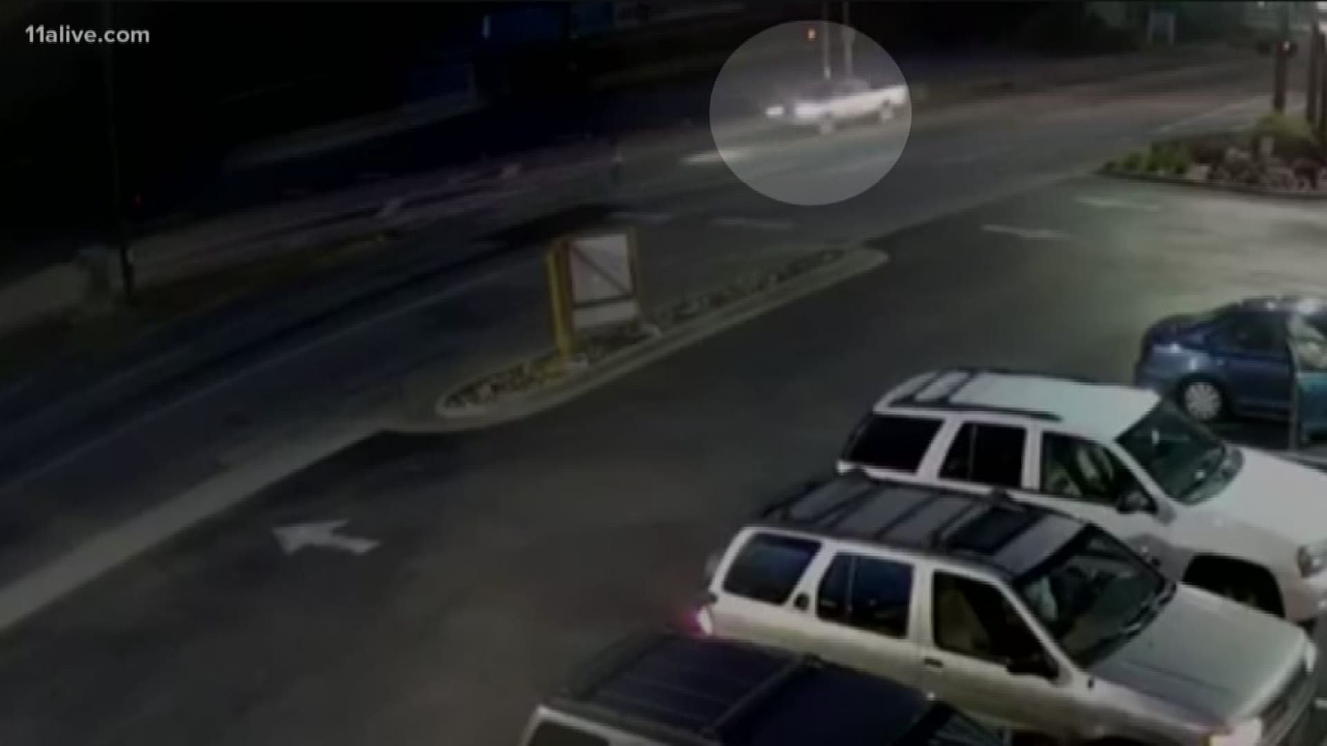 Police are on the lookout for a truck caught on camera striking a woman at an intersection on Friday night.