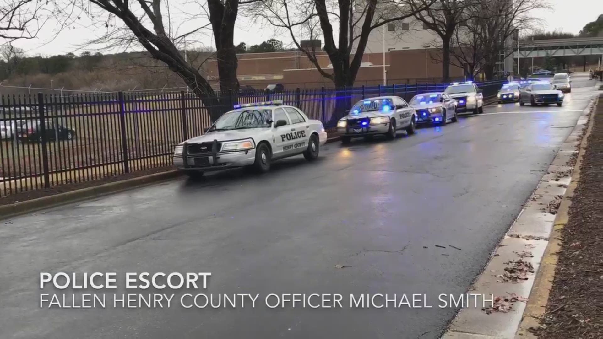 A procession of Henry County Police vehicles escorts the body of Officer Michael Smith to a funeral home on Fri., Dec. 29, 2018. Smith died after complications from a shooting on Dec. 8 in McDonough, Ga.