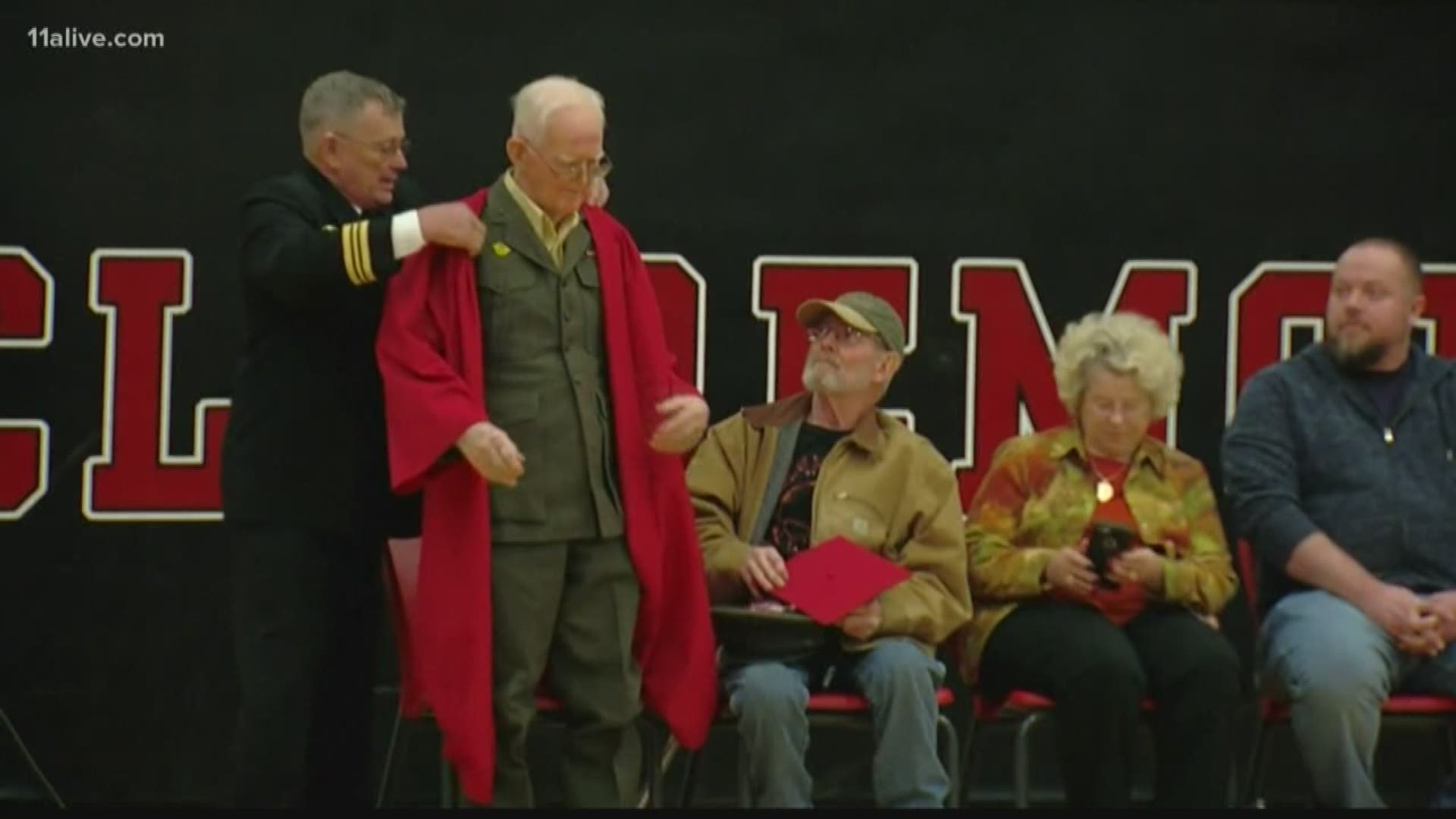 Dressed in his original Marine uniform, 95-year-old Veteran Lewie Shaw finally received his high school diploma.