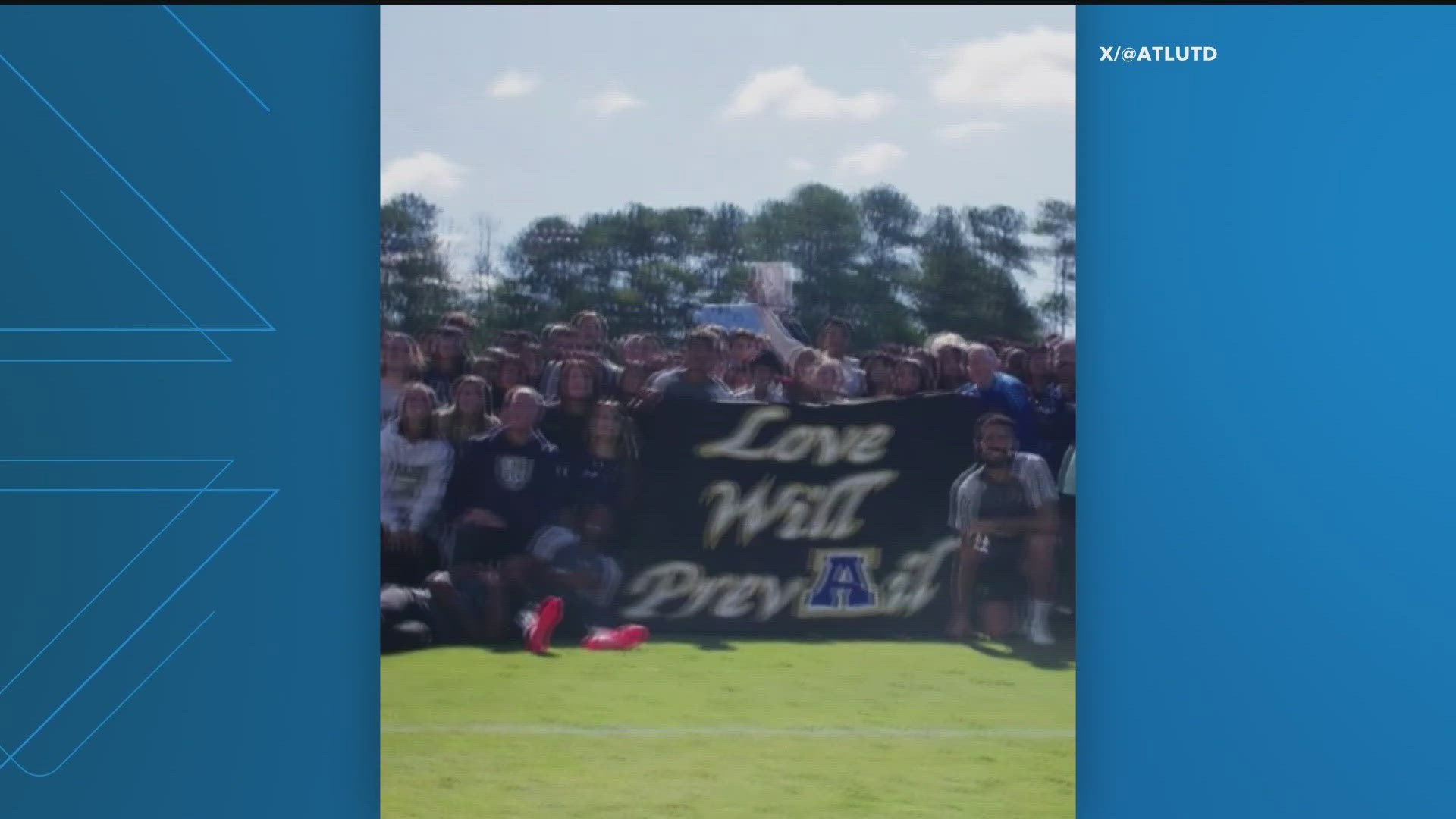 The soccer teams help up a banner that said "Love Will Prevail" in the aftermath of a deadly school shooting that killed four people.