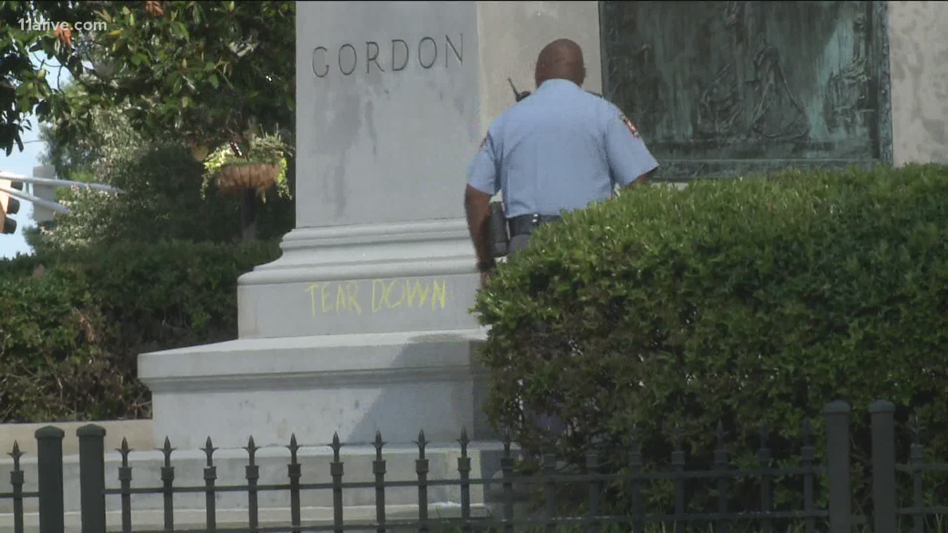 A statue of a Confederate general and one of Georgia's former governors was defaced with the words "tear down" during the sixth night of protests on the Capitol lawn