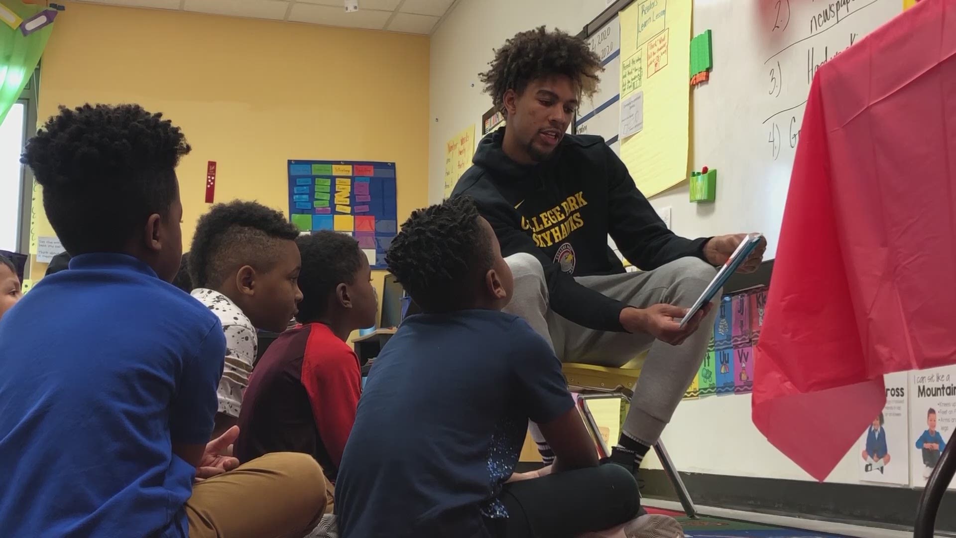 The College Park Skyhawks prove that reading is FUNdamental for the students of College Park Elementary School for National Read Across America Day