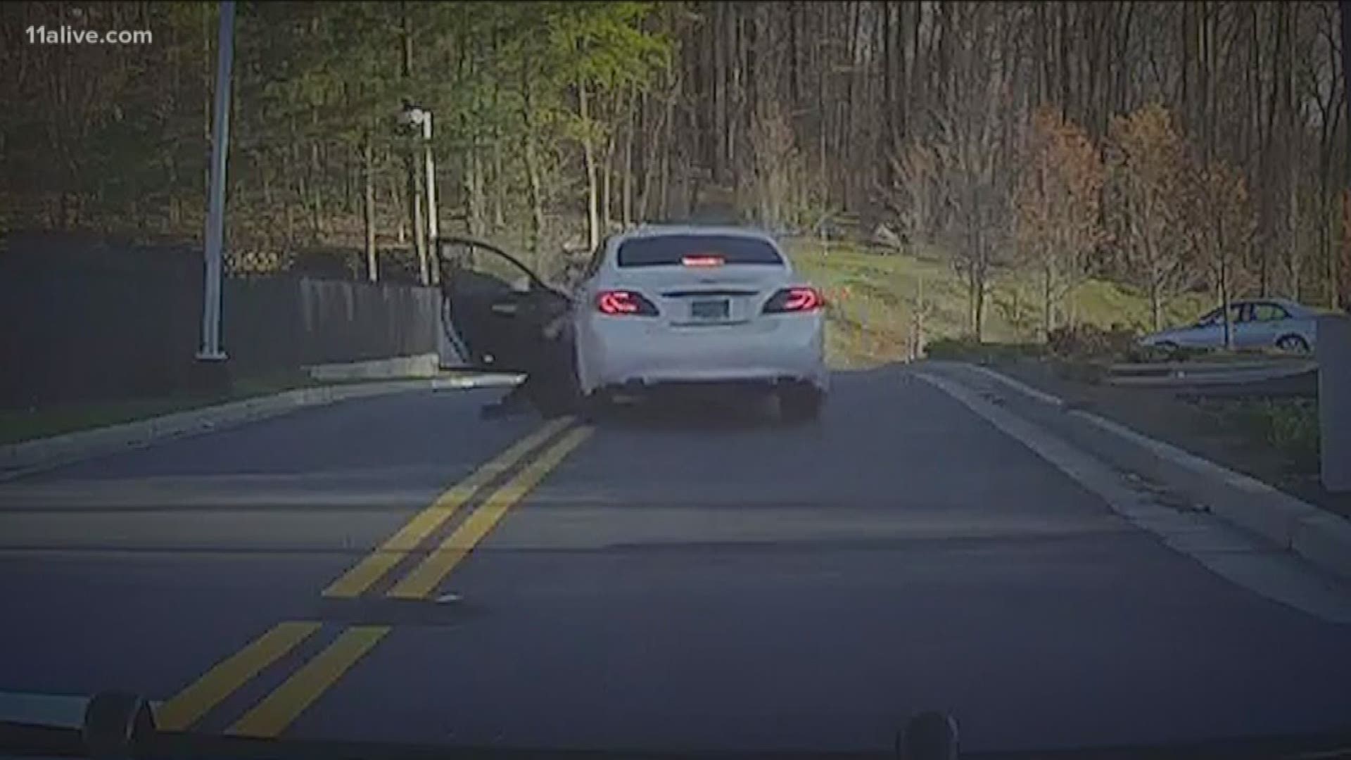 Video shows a suspected impaired driver dragging an officer several feet in his car.