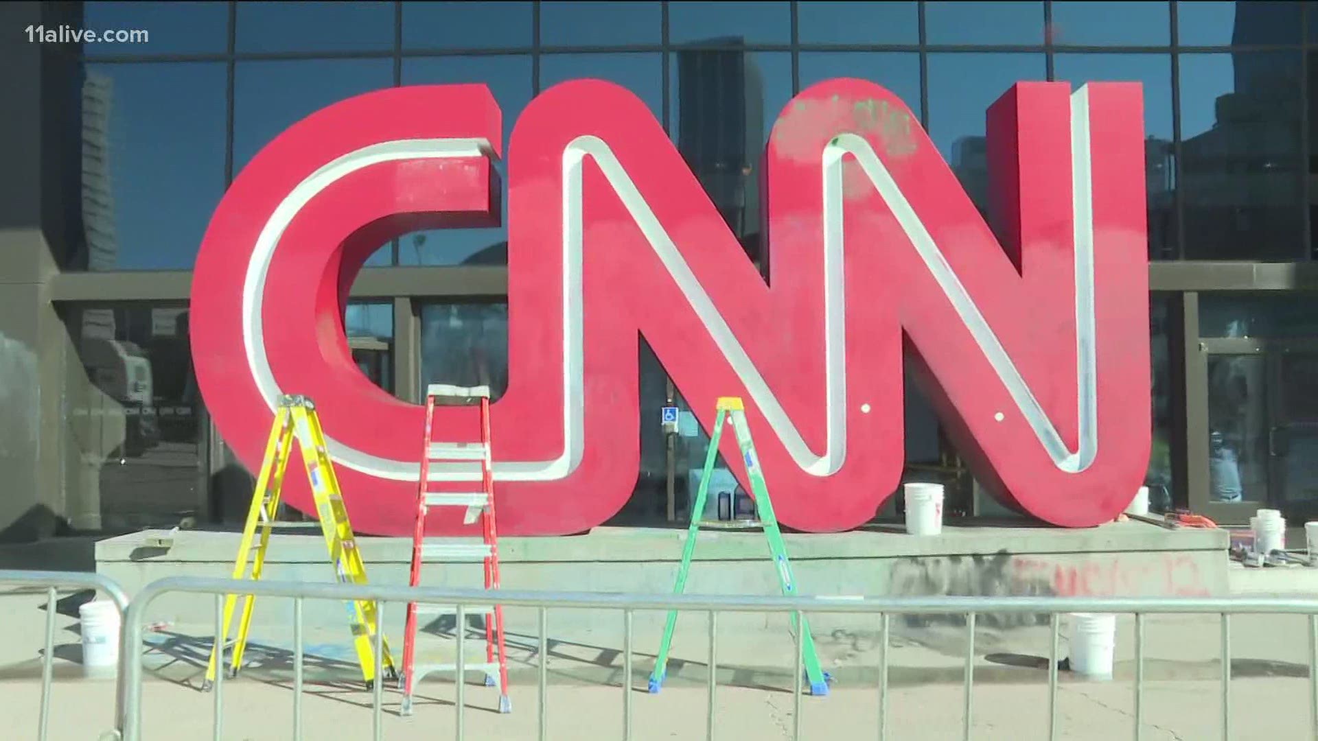 Only hours after Friday night's vandalism and damage, crews were hard at work, repairing the entrance and iconic sign outside the entrance to CNN Center in Atlanta.
