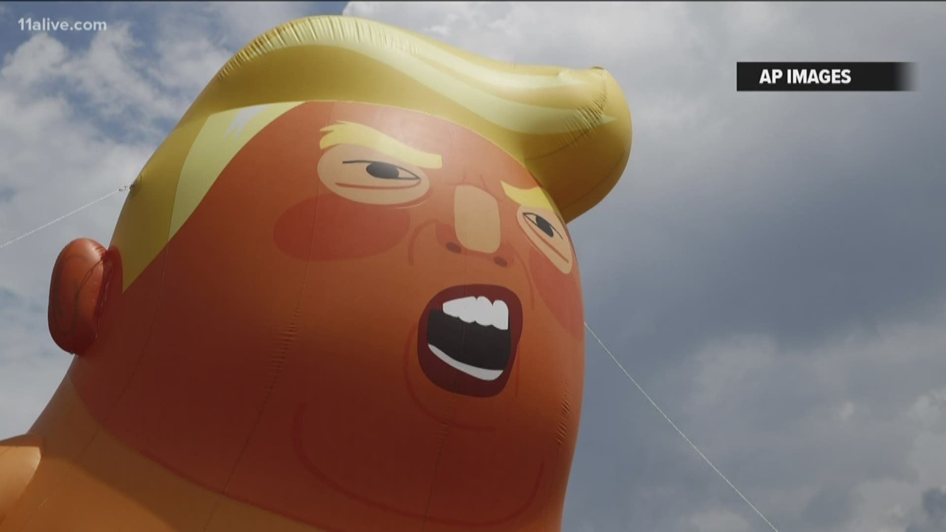 The towering Baby Trump balloon was set up in a nearby park during the president's visit for the highly anticipated college football matchup in Alabama.
