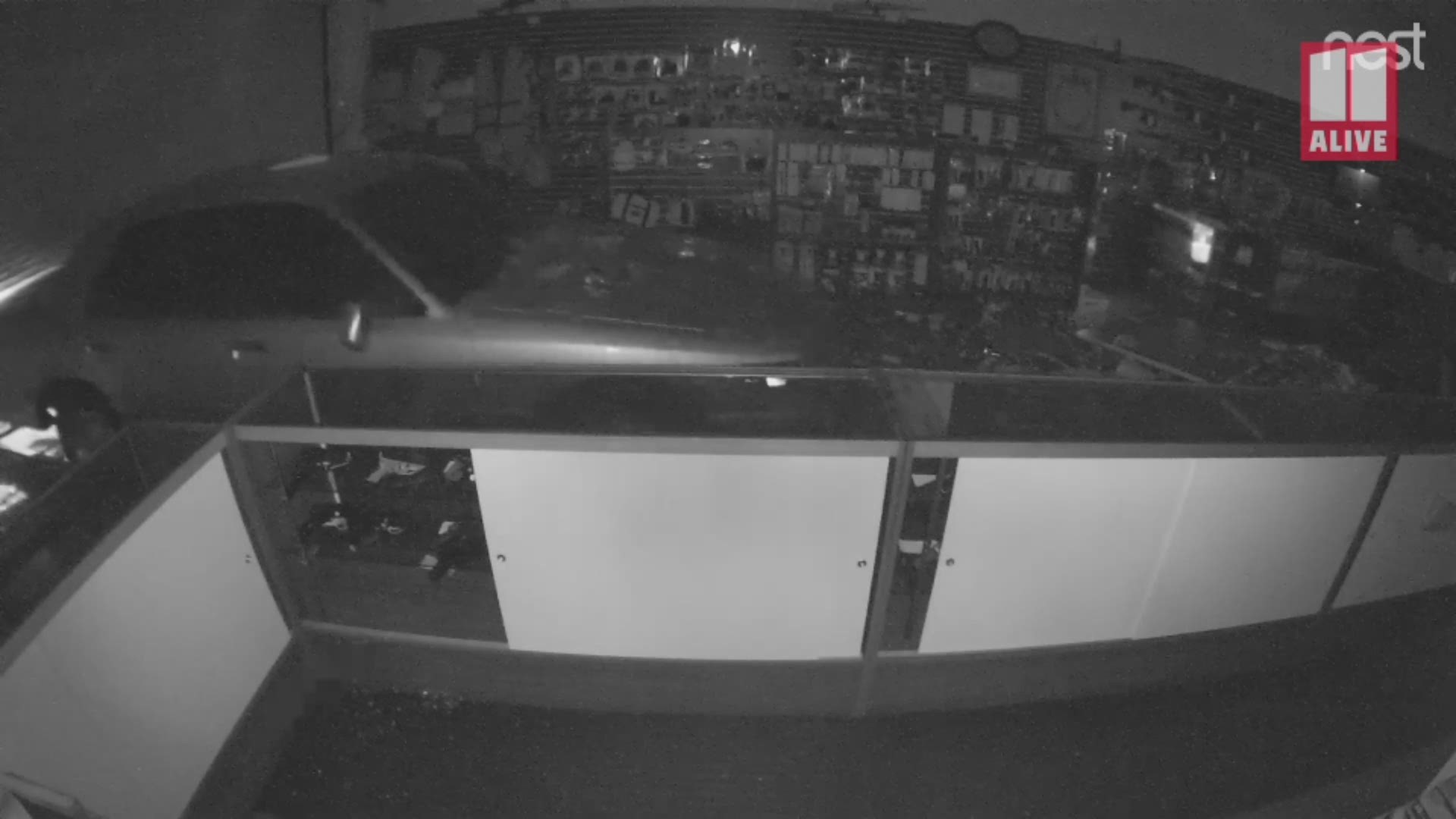 The driver slammed a stolen car into the store front and quickly made off with as many guns as he could carry. Now police need help identifying him.