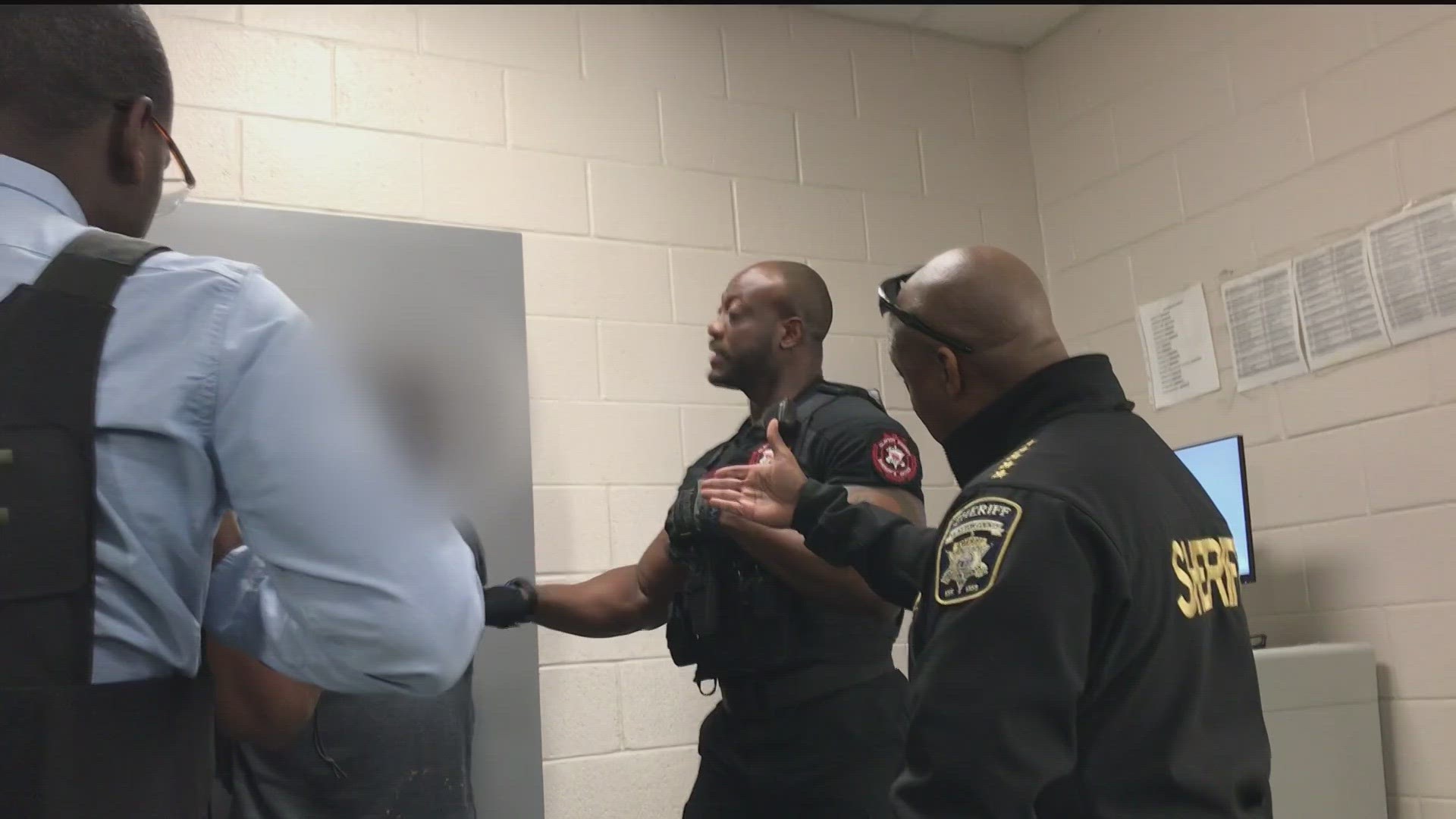 In the video, Hill is seen walking into a holding cell to speak with the man who was just arrested, asking what he was doing in Clayton County.