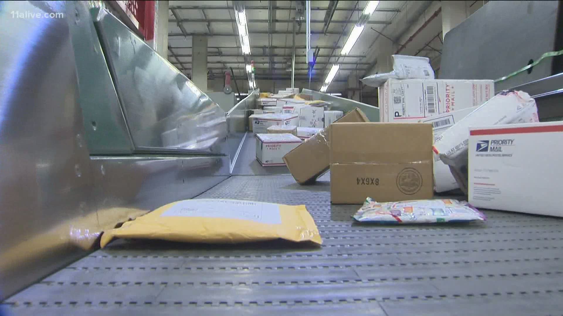 The postmaster general said he would “suspend” his initiatives until after the election “to avoid even the appearance of impact on election mail.”