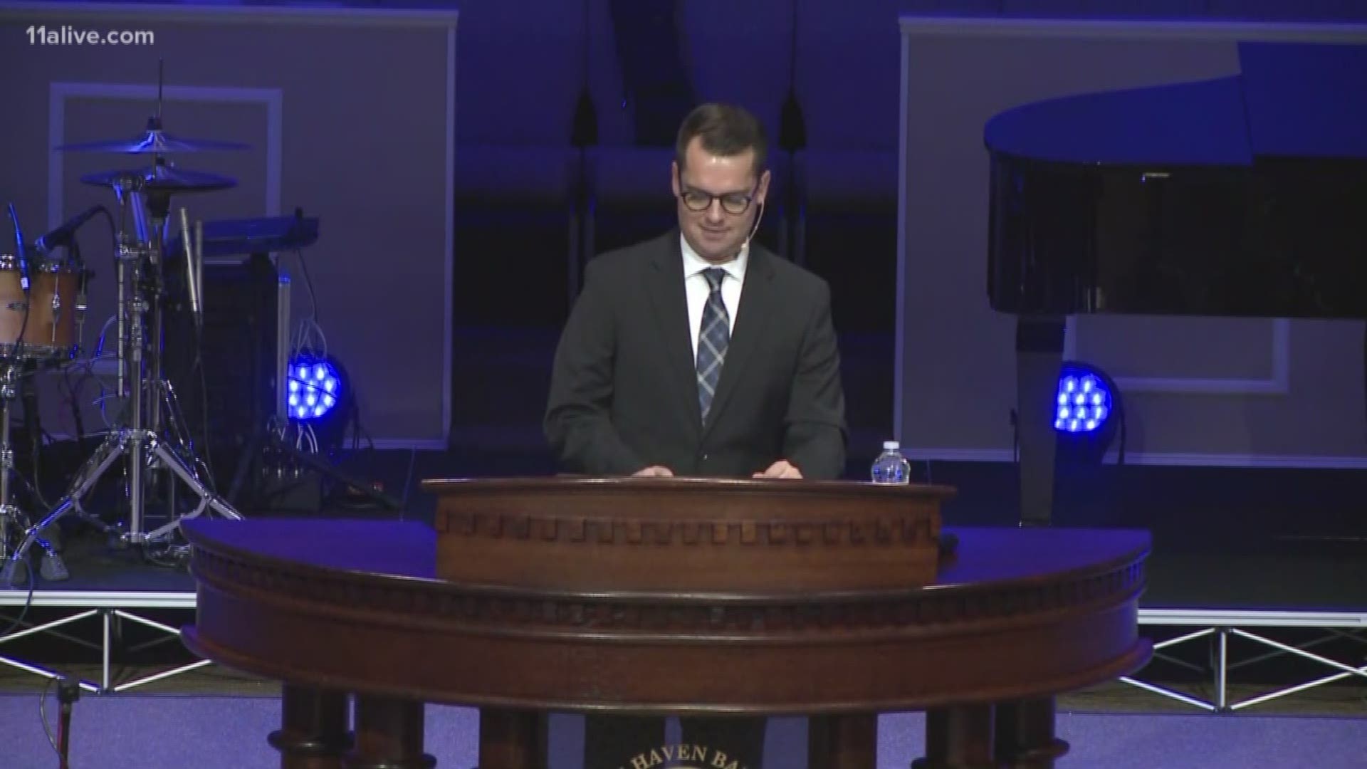 Pastor Stone reads stories from people who know Officer Michael Smith.