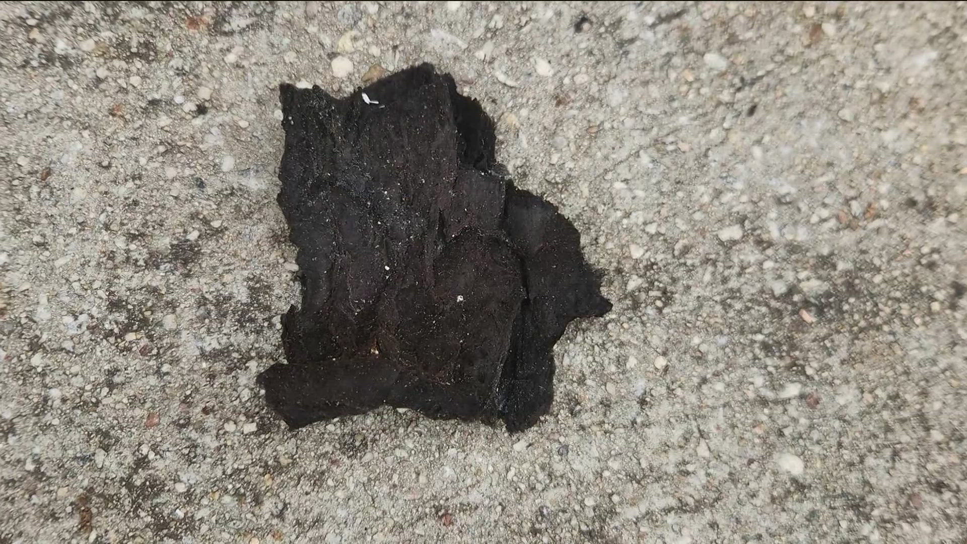 Farmers near the BioLab plant sent photos of scattered pieces of black debris in the grass, but they are unsure what it is.