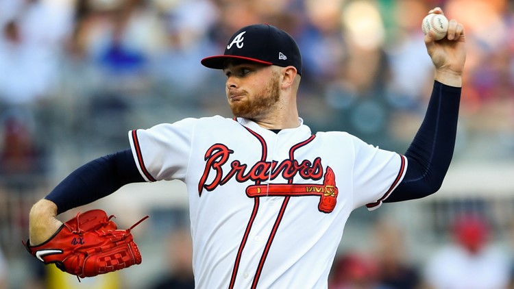 Atlanta Braves team members bow their heads during the national