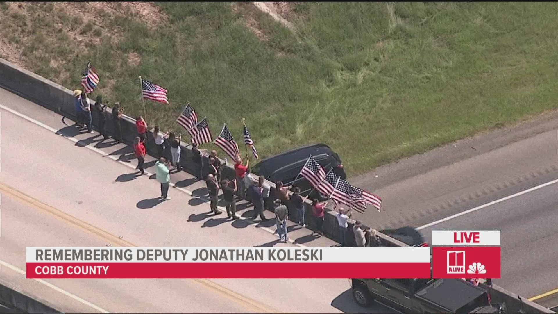 Community raises flags to honor Deputy Jonathan Koleski | 11alive.com