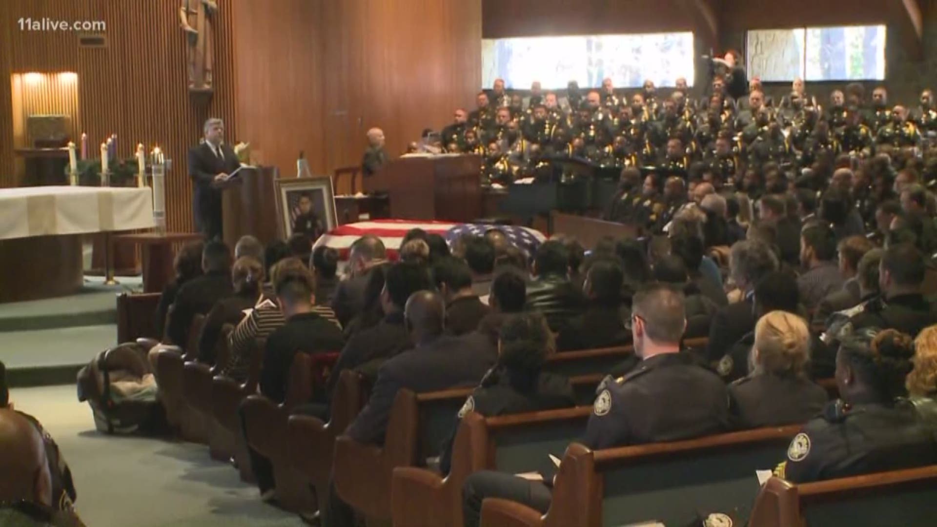 Law enforcement officers attend the funeral of Officer Edgar Flores.