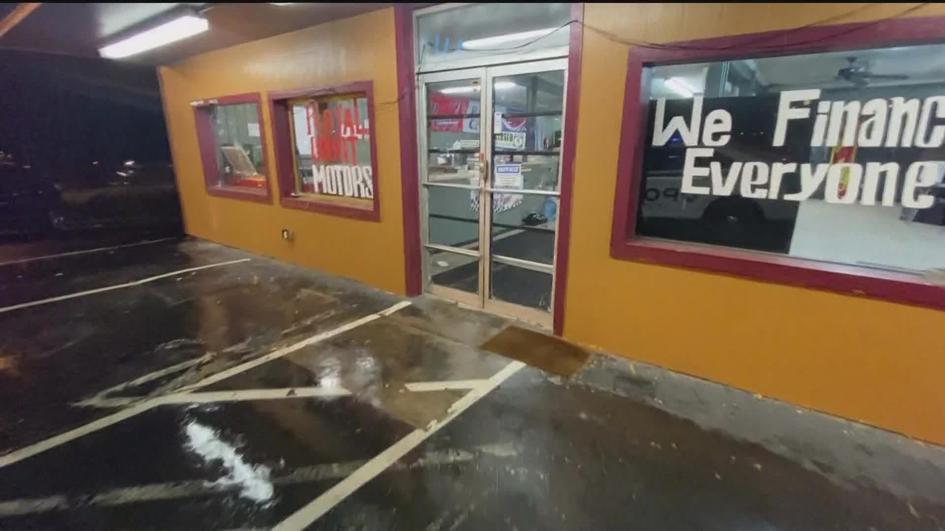 Man walks into used car dealership in County, shoots woman to