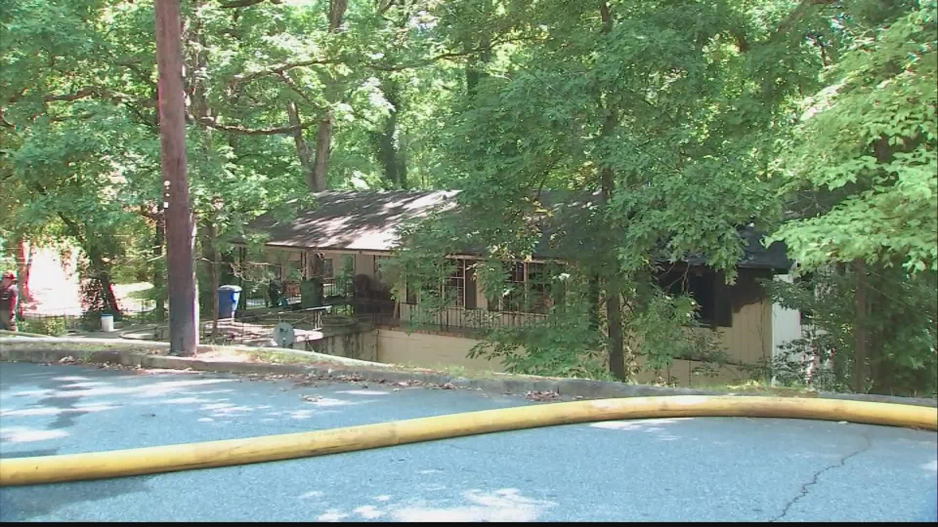 A neighbor called 911 and said the home next door was on fire and heard screams for help.