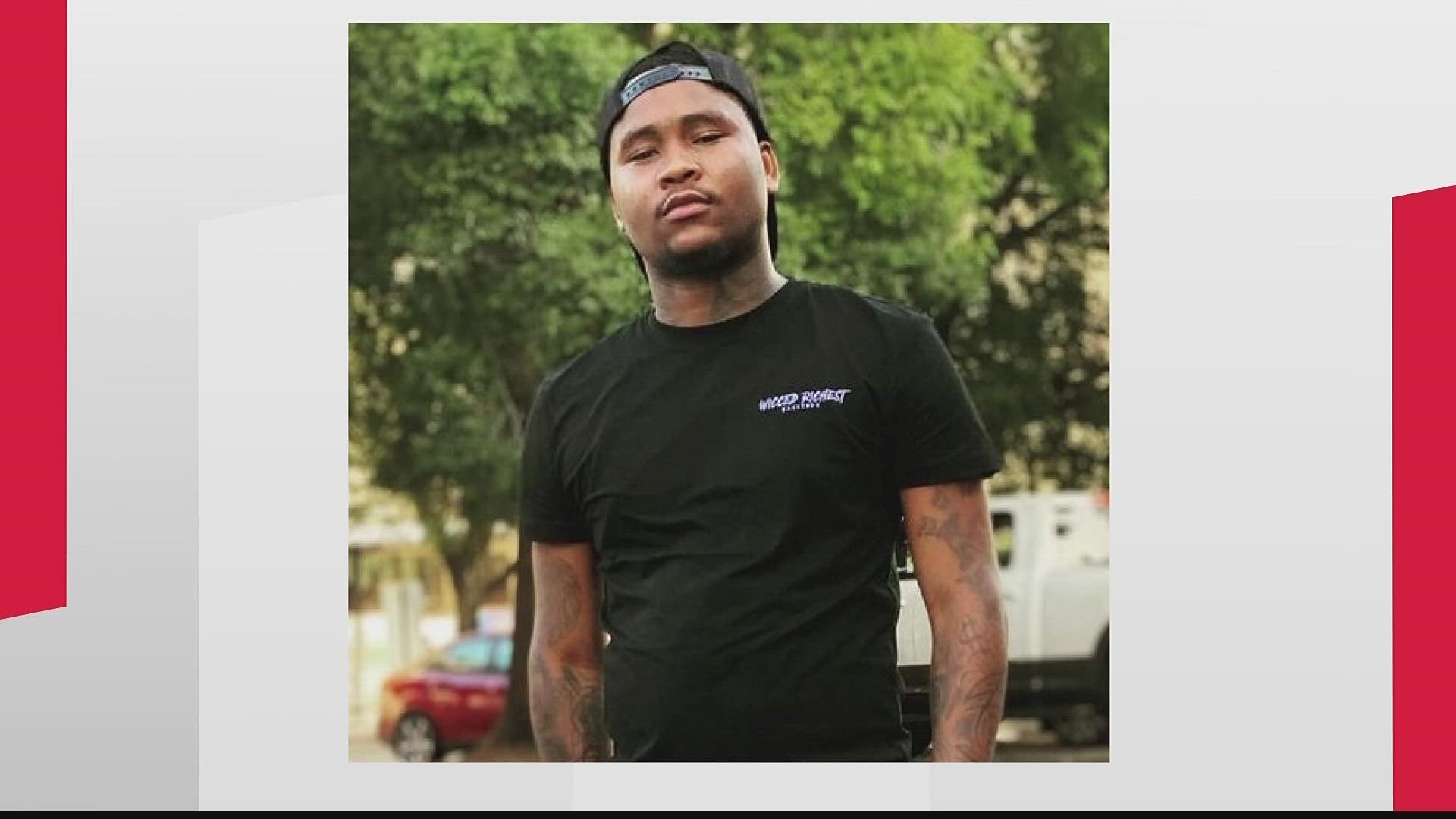 Atlanta Police are still looking for the person who shot and killed a 24-year-old father who his family said was walking a friend to her car when he was struck.