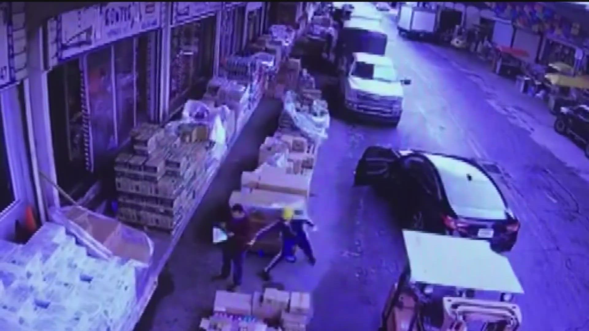 Surveillance video shows a man getting his wallet stolen, then being dragged by the thief's vehicle down an alley. Vendors say robberies happen about 4 times a week.