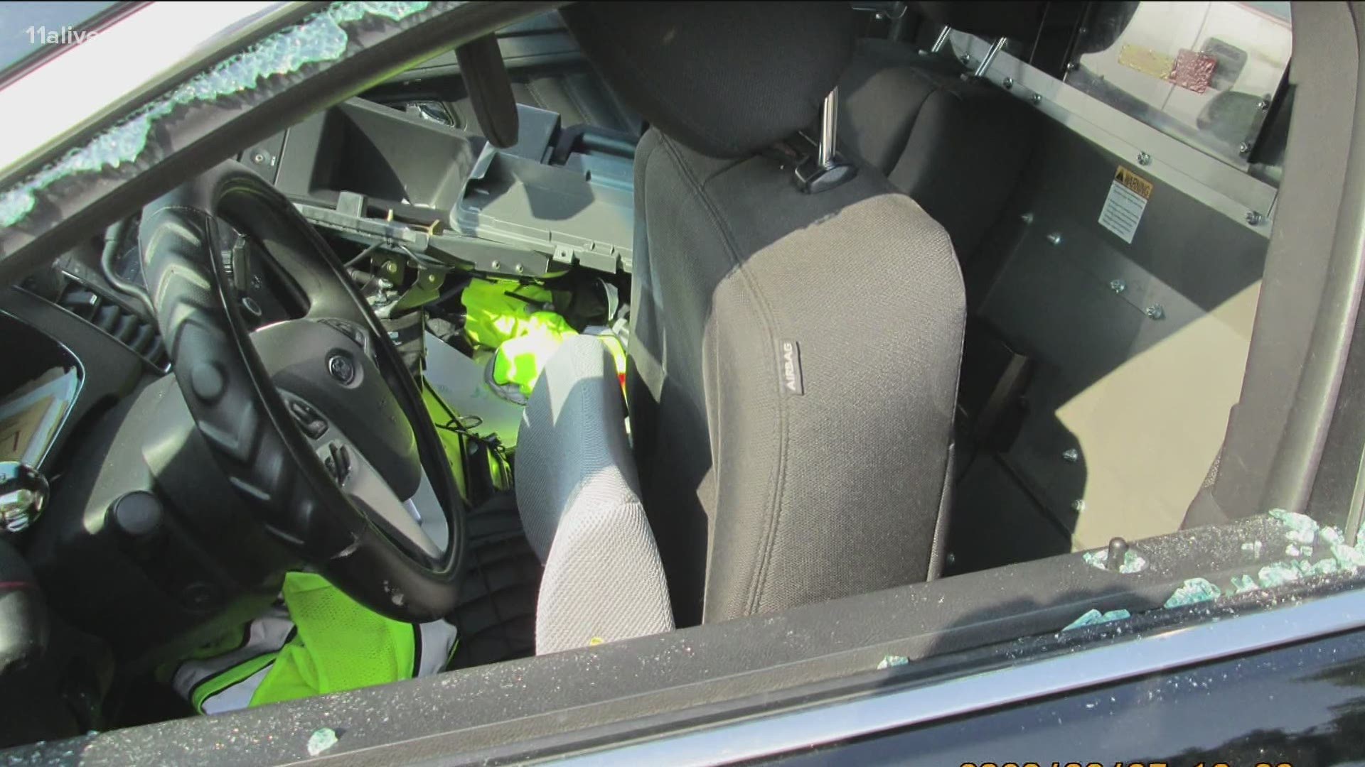 Police say four marked Cobb County Police Department vehicles had been dropped off for service had windows shattered and damage to the trunks and interiors.