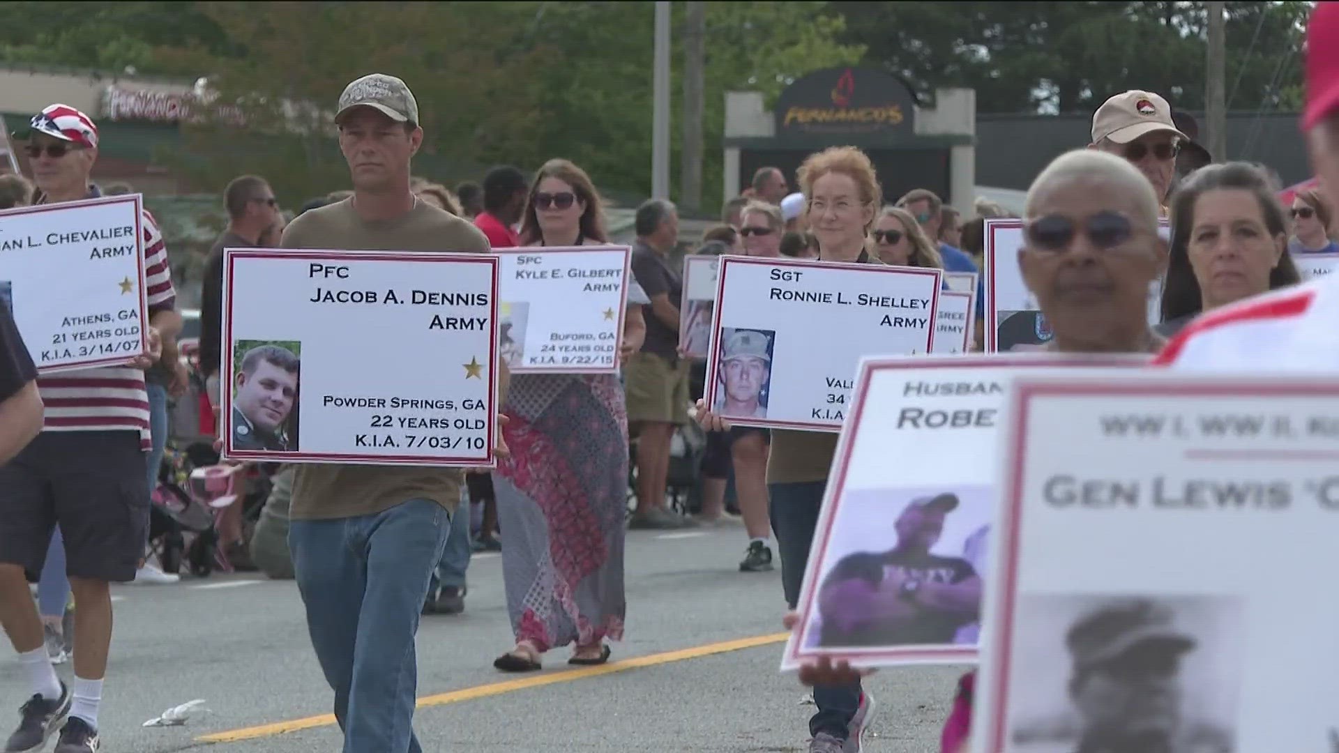 Each year, they carry signs displaying the names and pictures of over 300 fallen heroes.