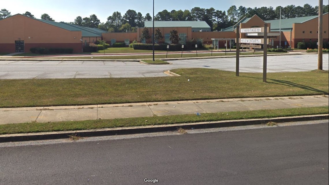 Heritage Elementary School employee carjacked by armed suspect