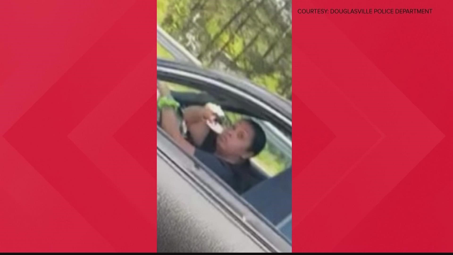 A woman pictured, apparently pointing a gun in a suspected case of road rage is now in custody.