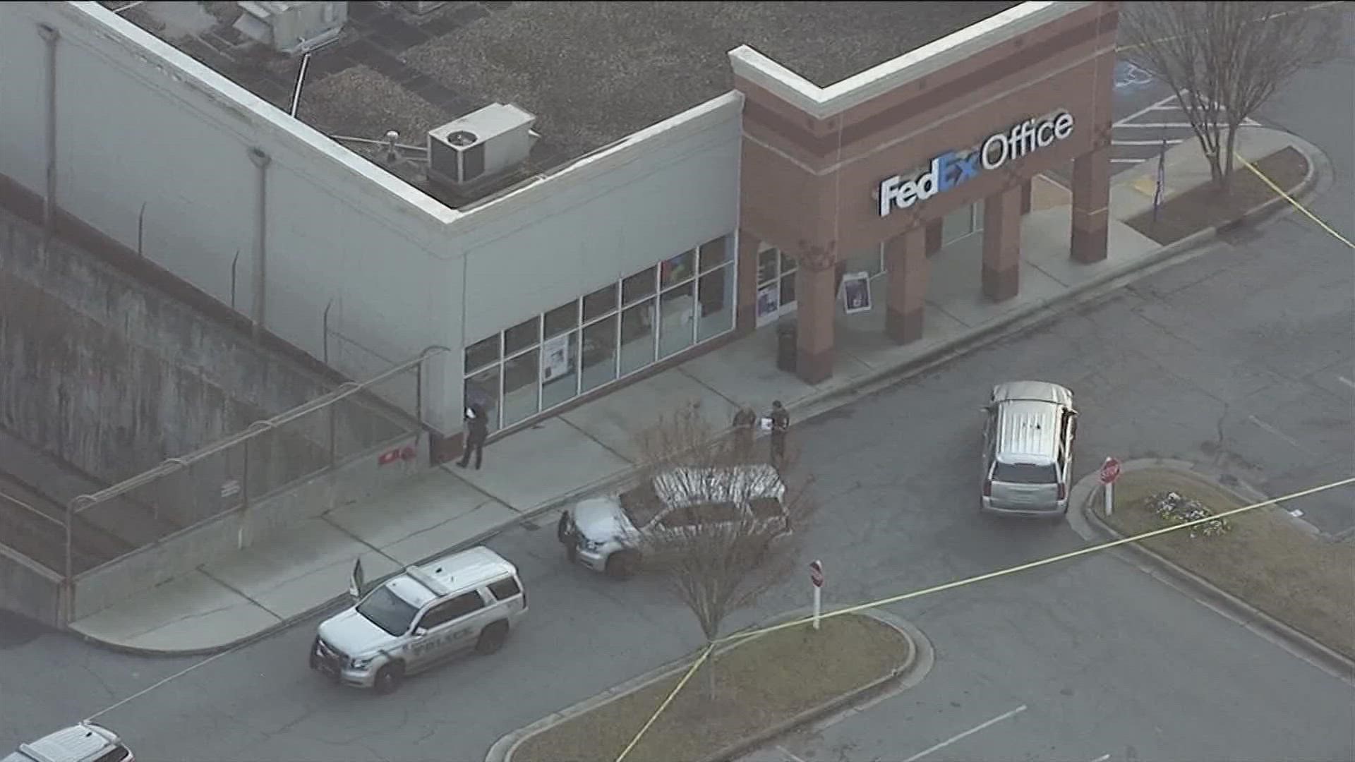 Authorities have taped off the area around the FedEx Office and the Total Wine parking lot. They are asking the public to avoid the area.