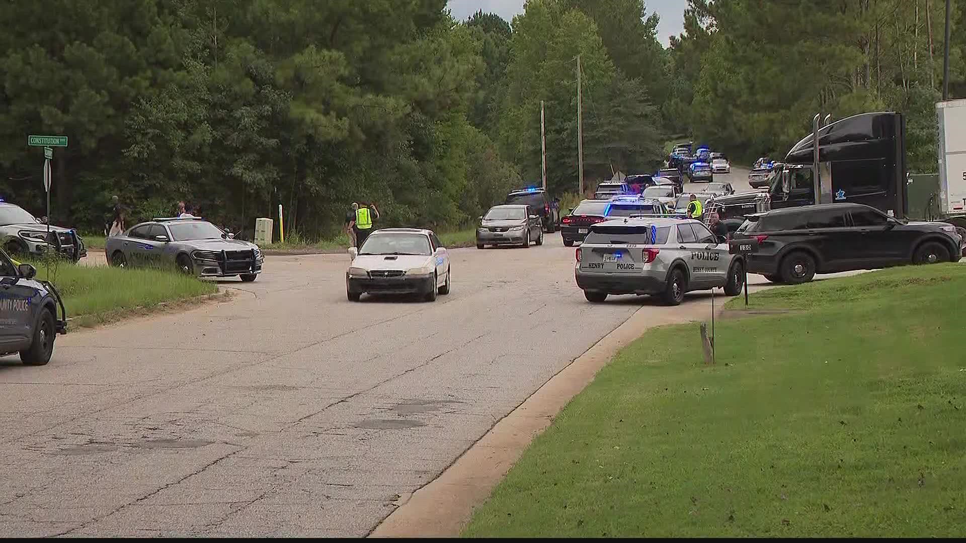 Three people were shot at a warehouse in McDonough on Thursday. Officials said they have a suspect in custody in connection to the shooting.