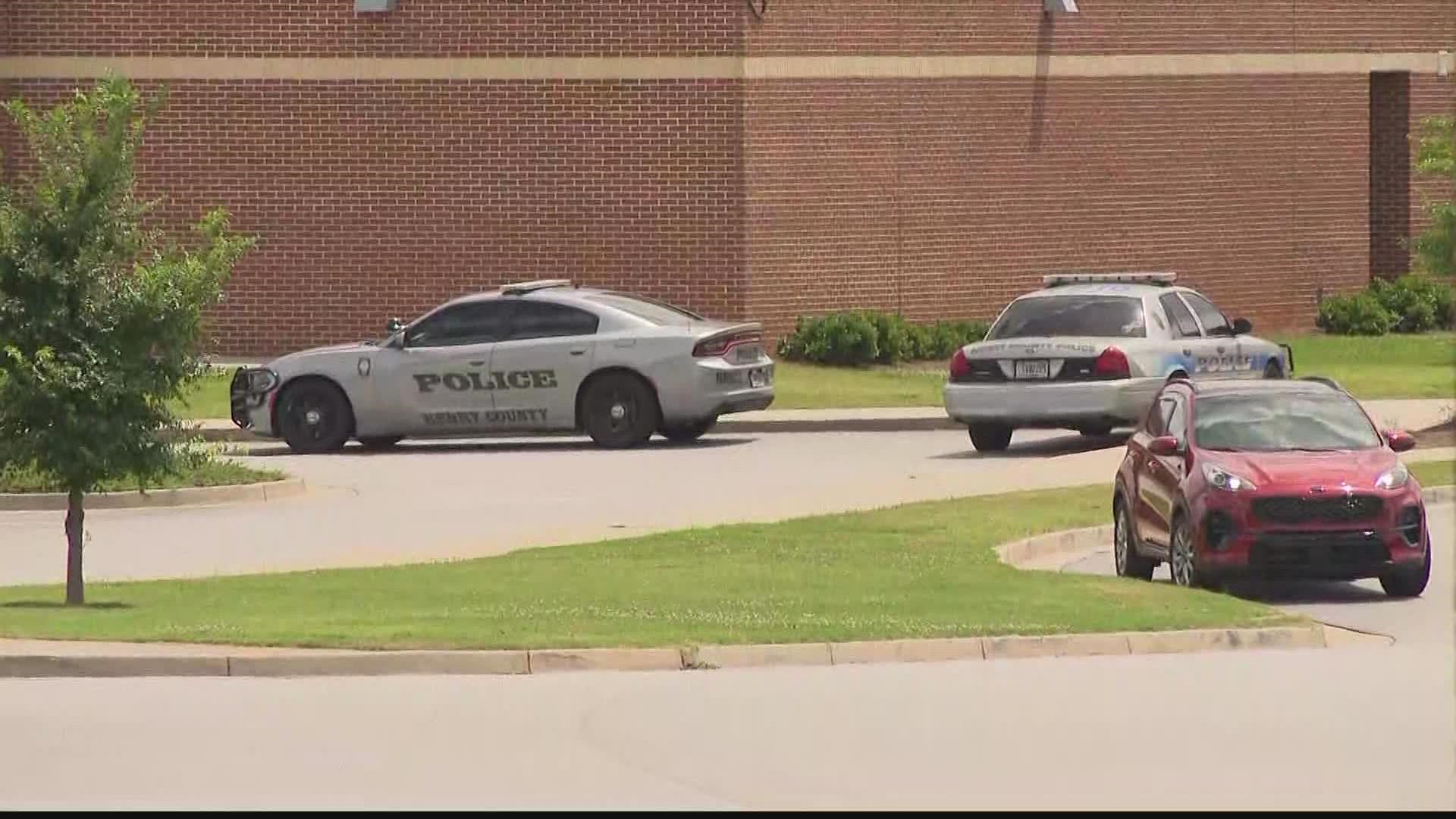 A high school student is charged after officials say the individual had two weapons on campus.