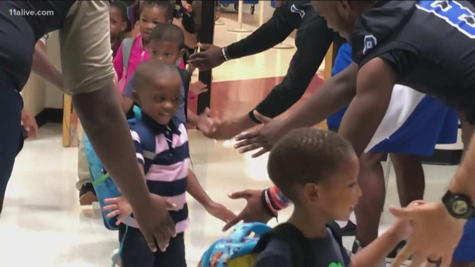The seniors who once attended the elementary school passed out supplies and gave high-fives!