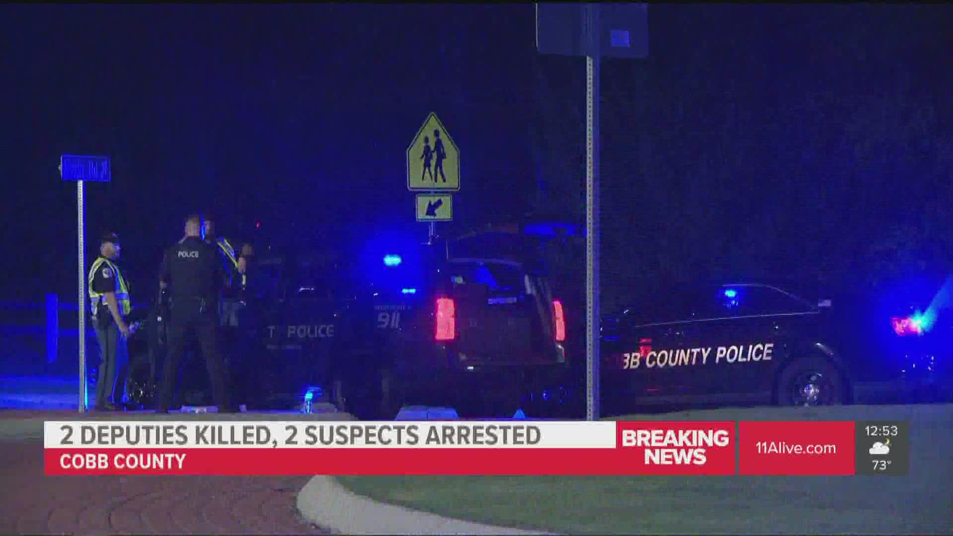 According to the Cobb County Sheriff, the deputies were ambushed while serving a warrant.