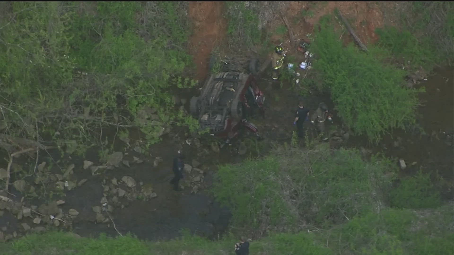11Alive's SkyTracker was over the scene, where the car was seen flipped over in a creek with what appeared to be at least a dozen first responders on scene.