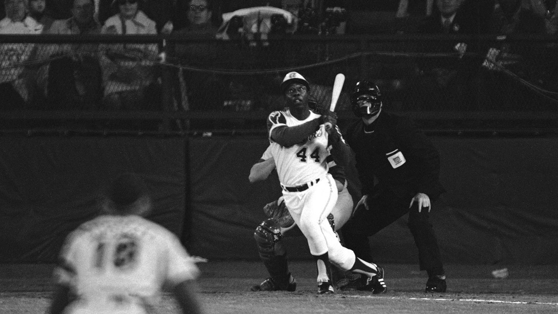 FILE - In this Sept. 30, 1969, file photo, a Major League Baseball 100th  anniversary patch is shown on the uniform of Atlanta Braves team captain  Hank Aaron, left, as he watches