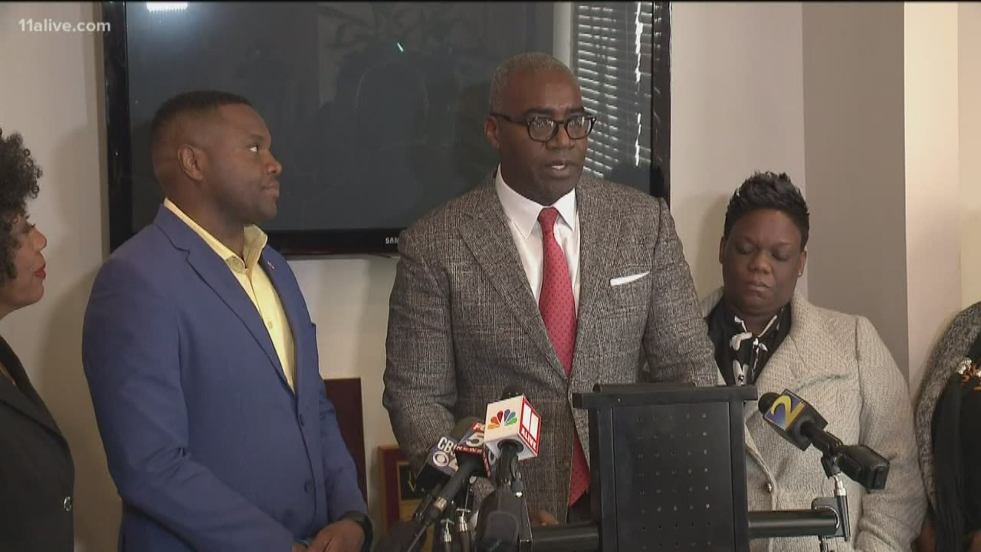 The councilors, Latresa Akins-Wells and Dabouze Antoine, announced their intention to file suit against the city and its police department.