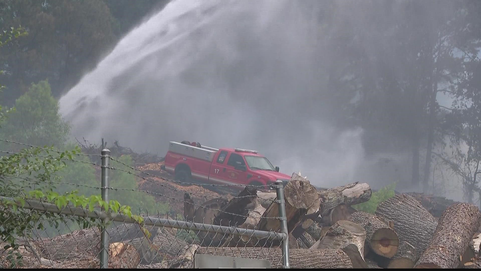 Firefighters worked to put out a blaze outside an auto repair shop in Lithonia Saturday.