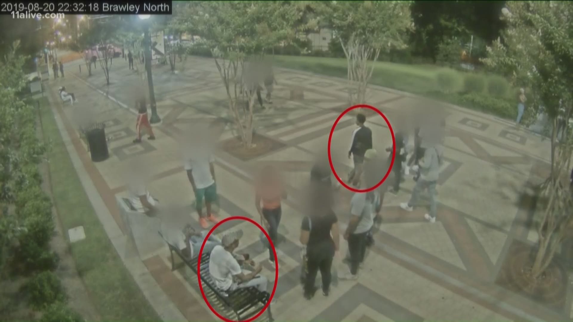 The new video shows the new suspect wearing a long sleeve black shirt with a thick white stripe down the arm.