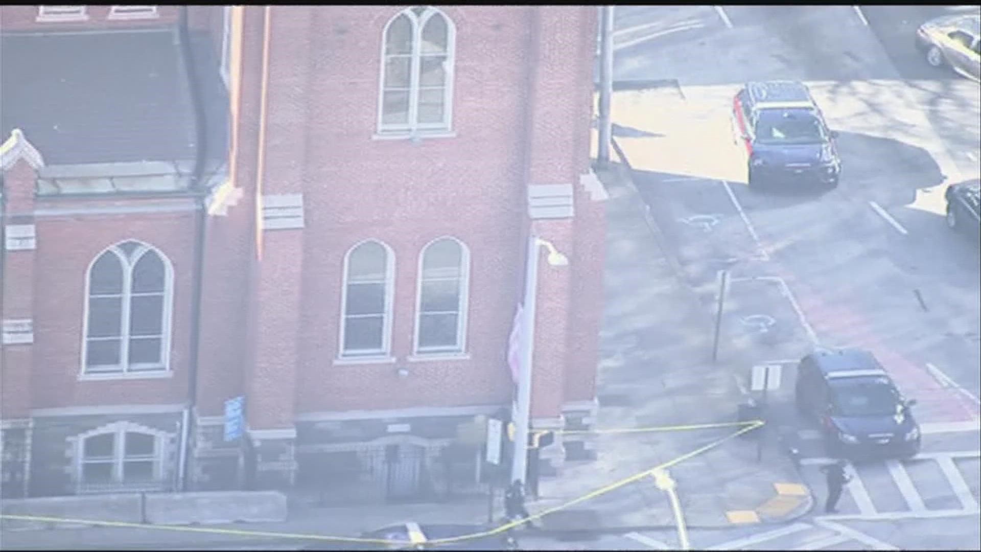 Police were seen blocking a street while roping off a building with crime scene tape.