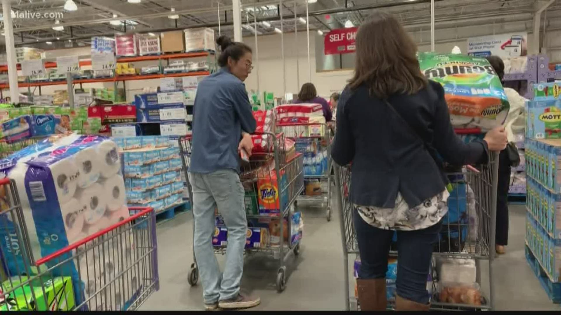 People staying home from work and school flocked to grocery and big box stores Friday.